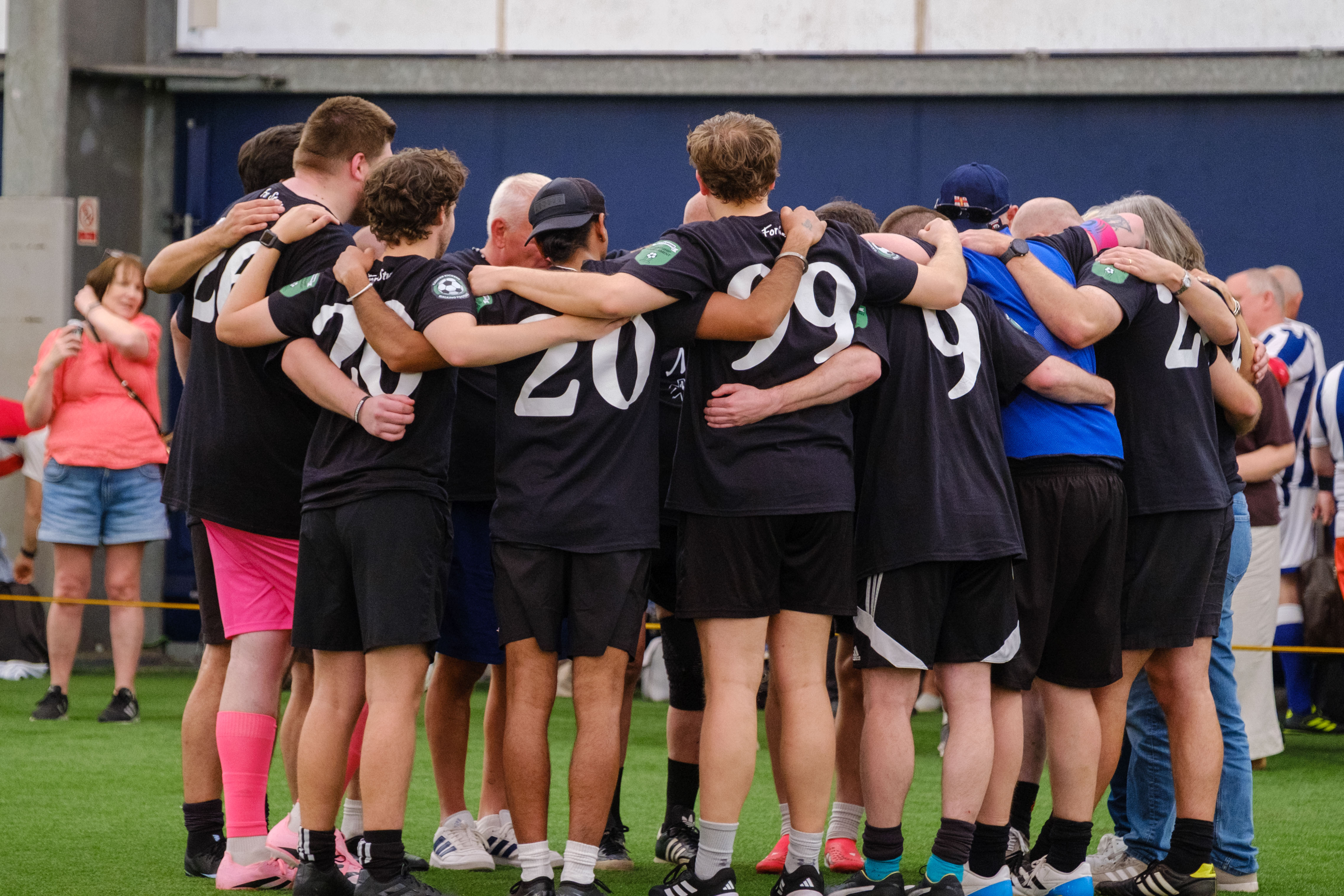 Moore than Cancer team huddle before the final.