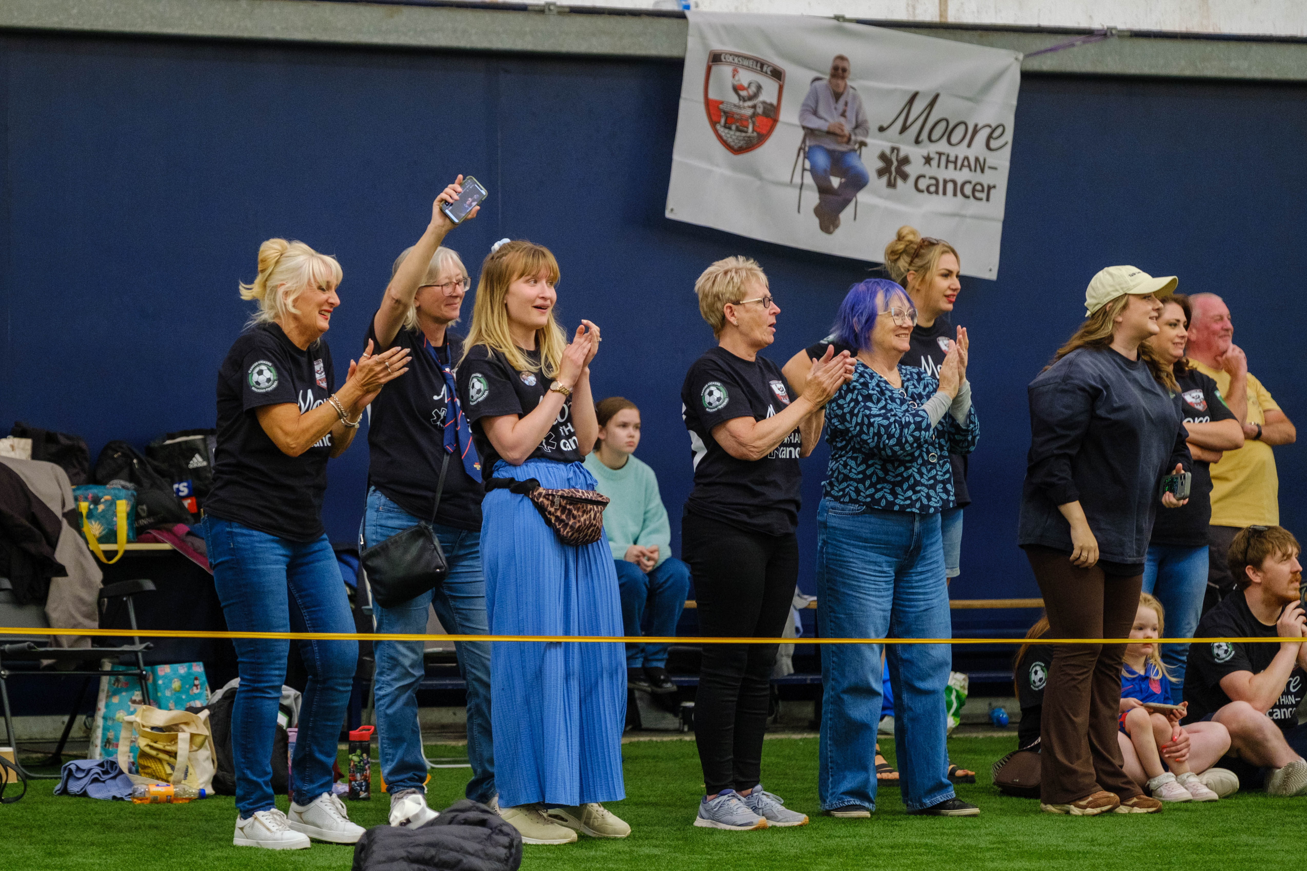Moore than Cancer spectators cheering on the sideline.