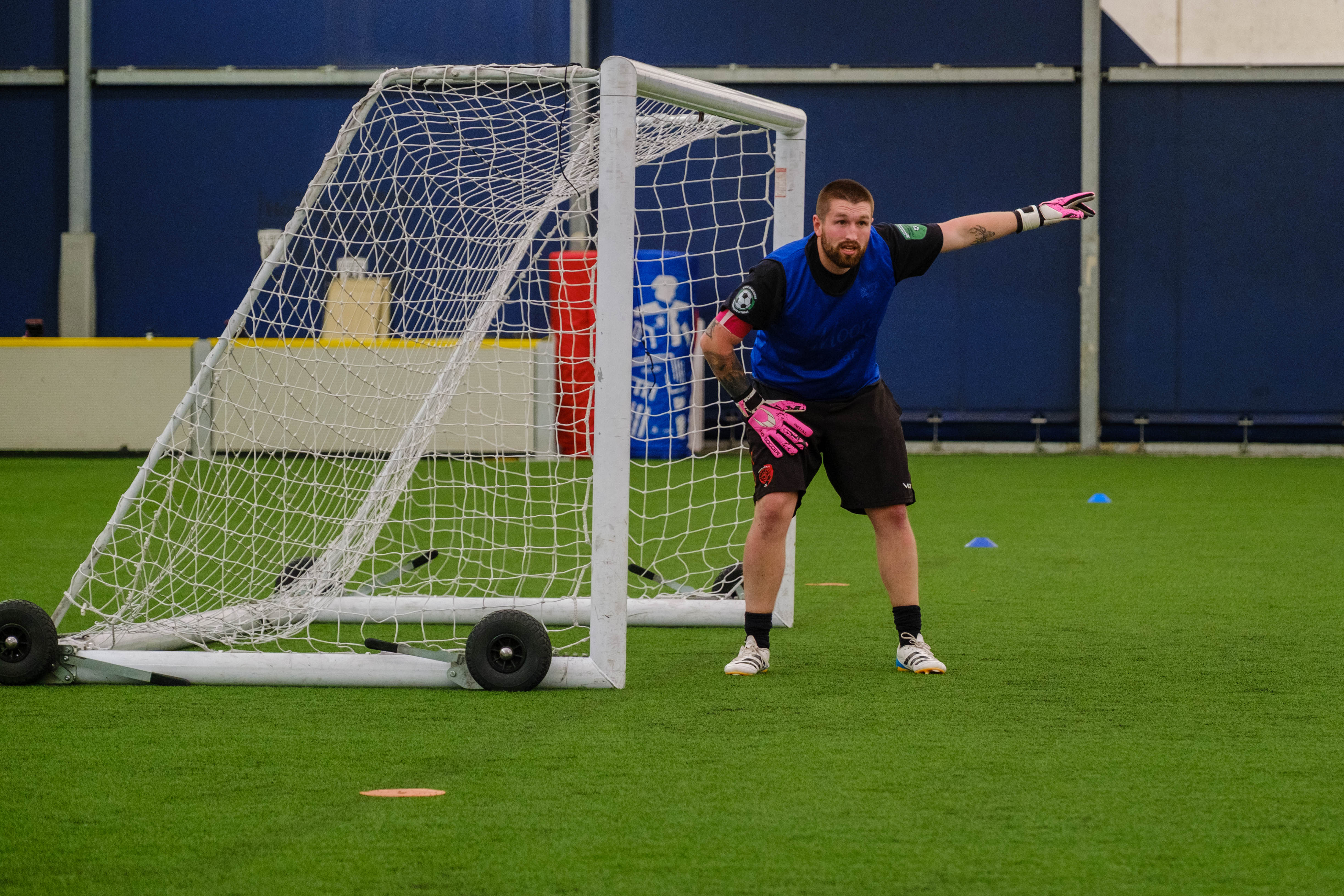 Moore than Cancer goalkeeper signalling out to his left.