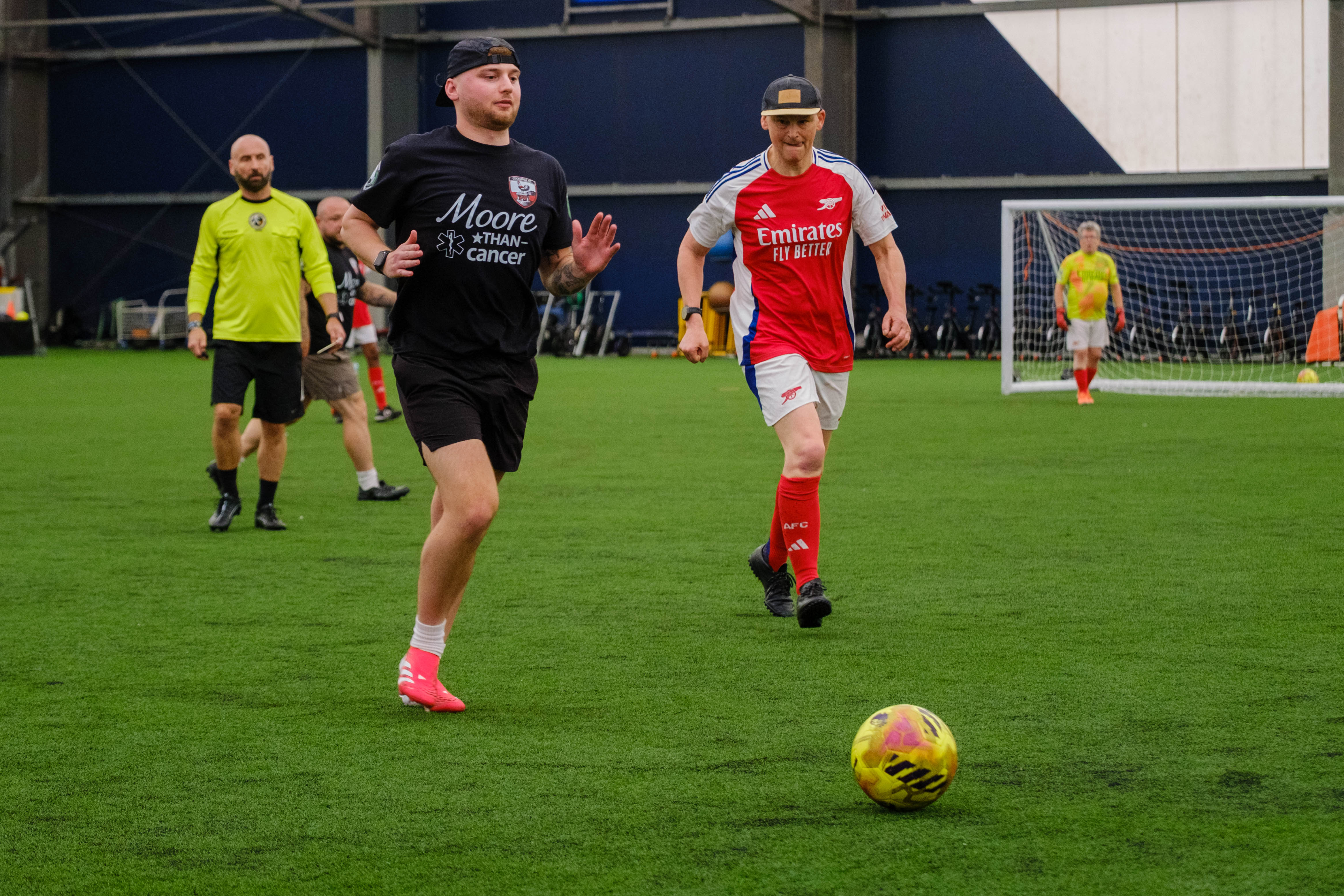 Moore than Cancer and Arsenal player chasing down the ball.