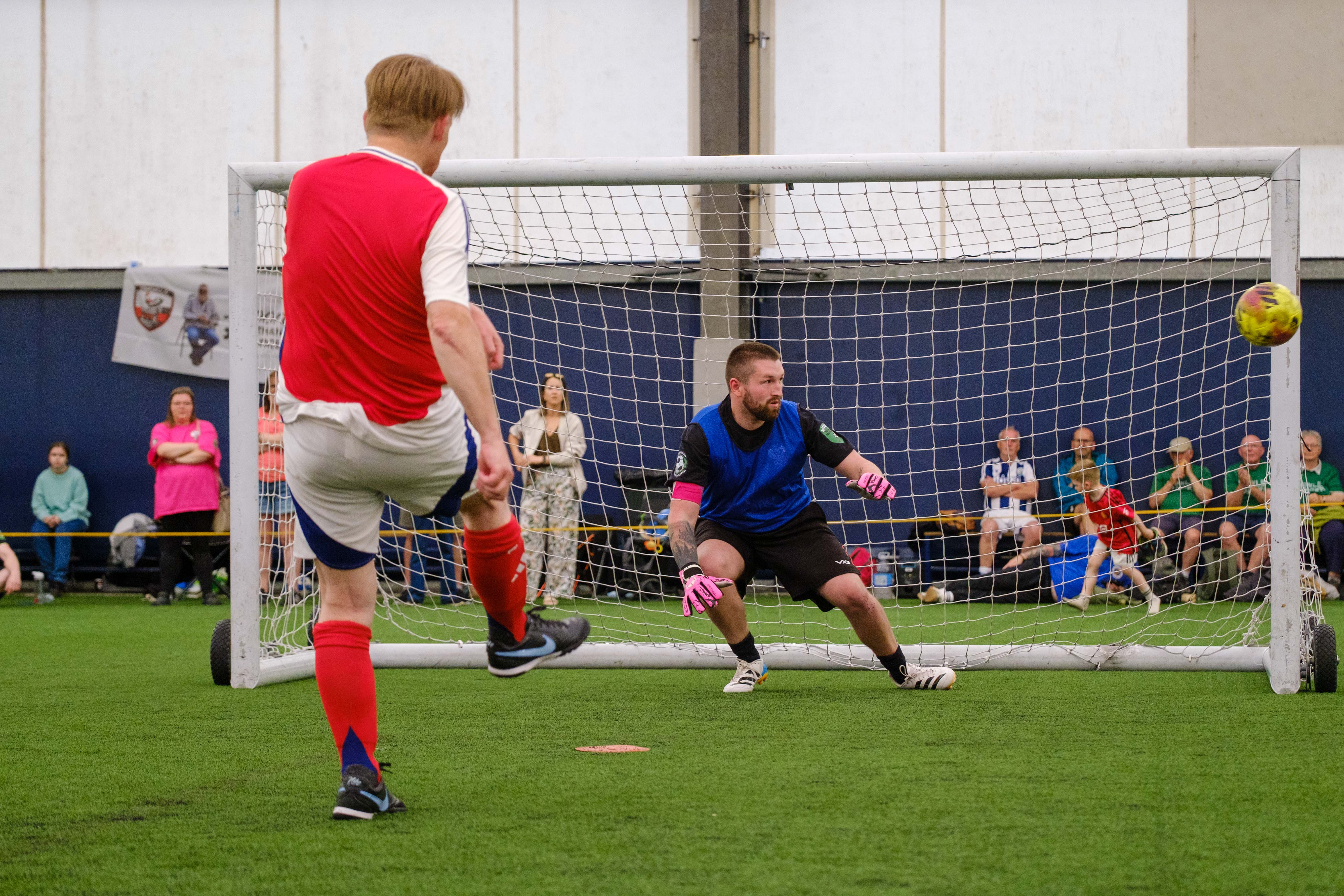 Arsenal player striking his penalty which hits the post.