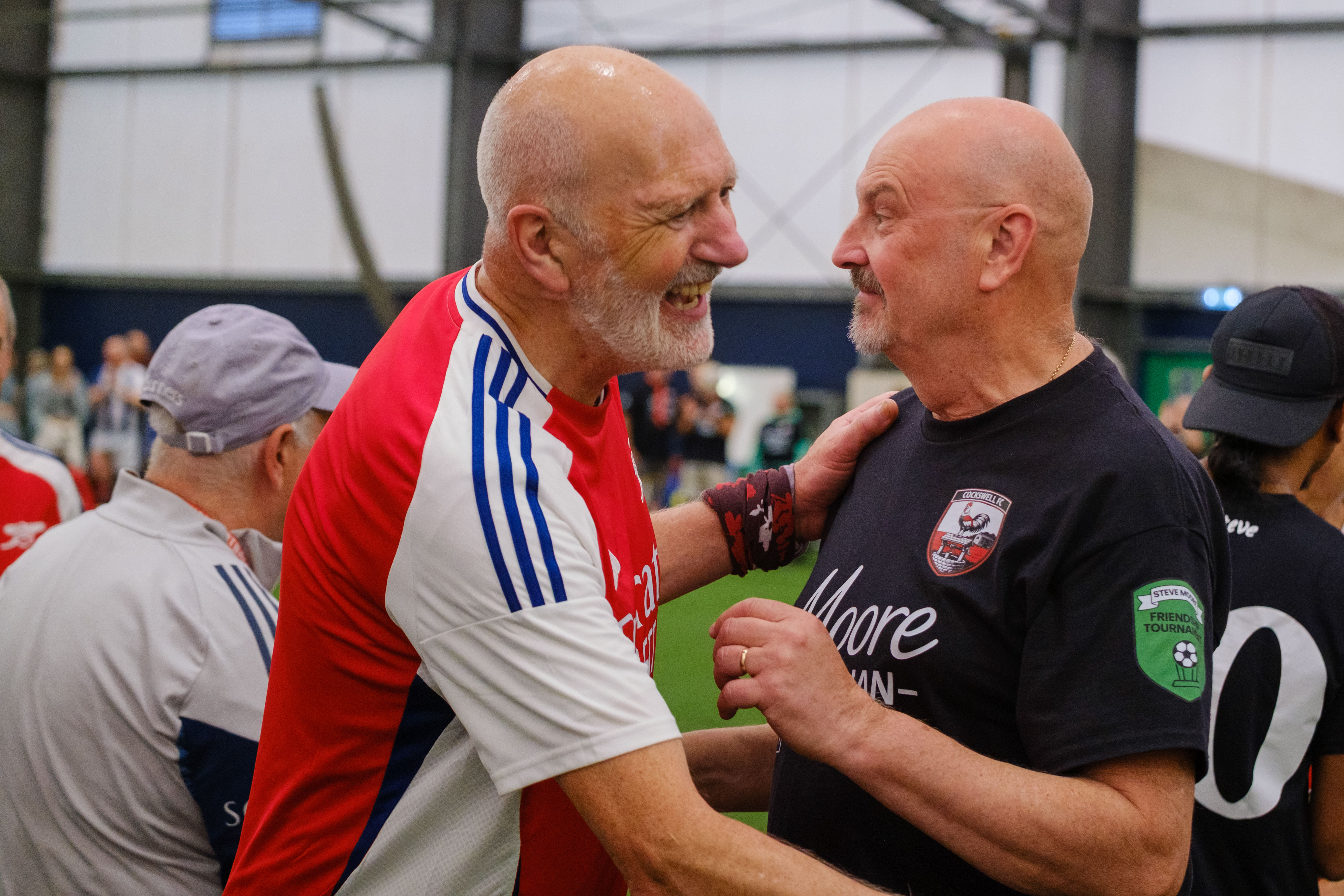 Close-up of Arsenal and Moore than Close players embracing after the match
