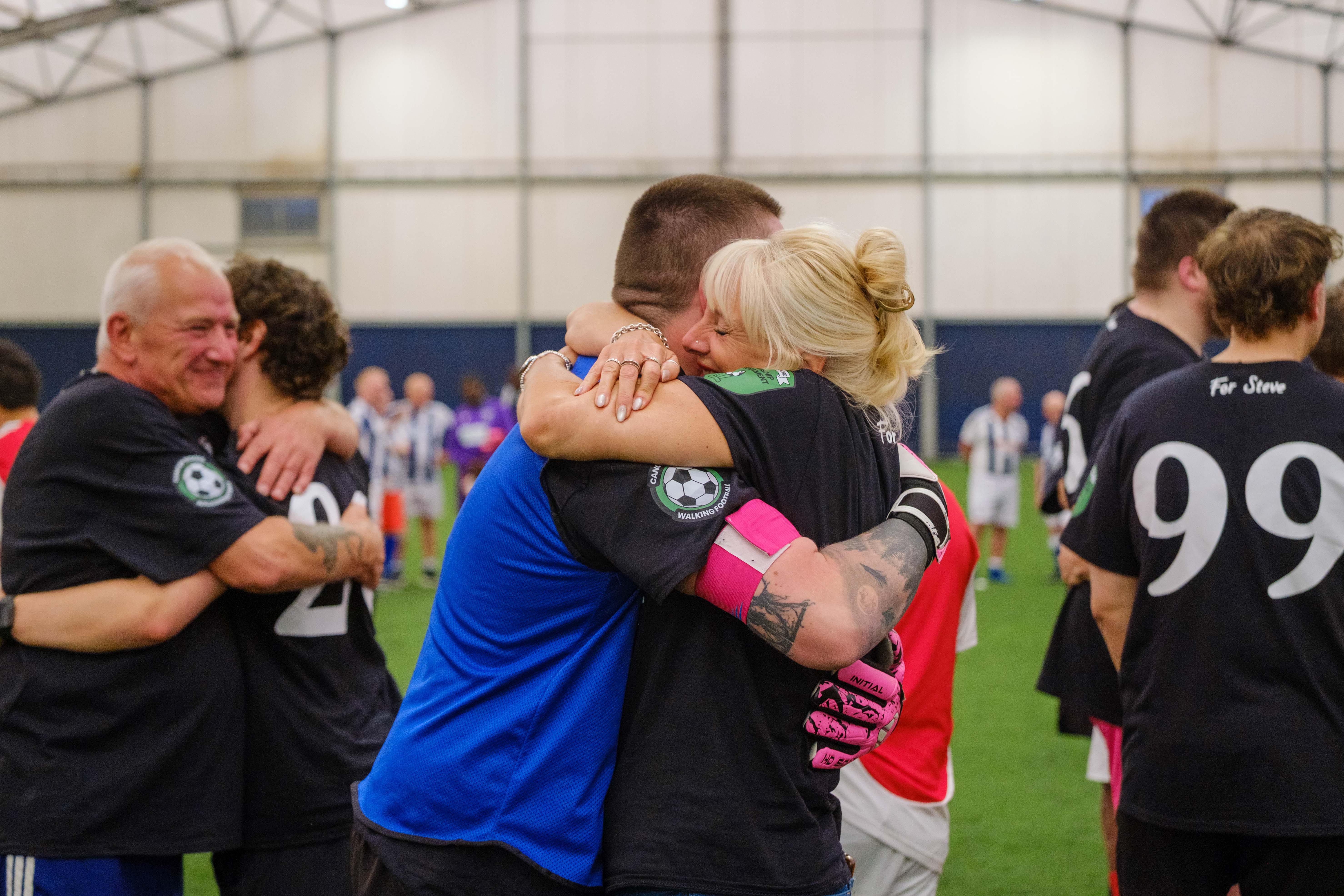 Ruth Moore hugging Moore than Cancer goalkeeper after the match.