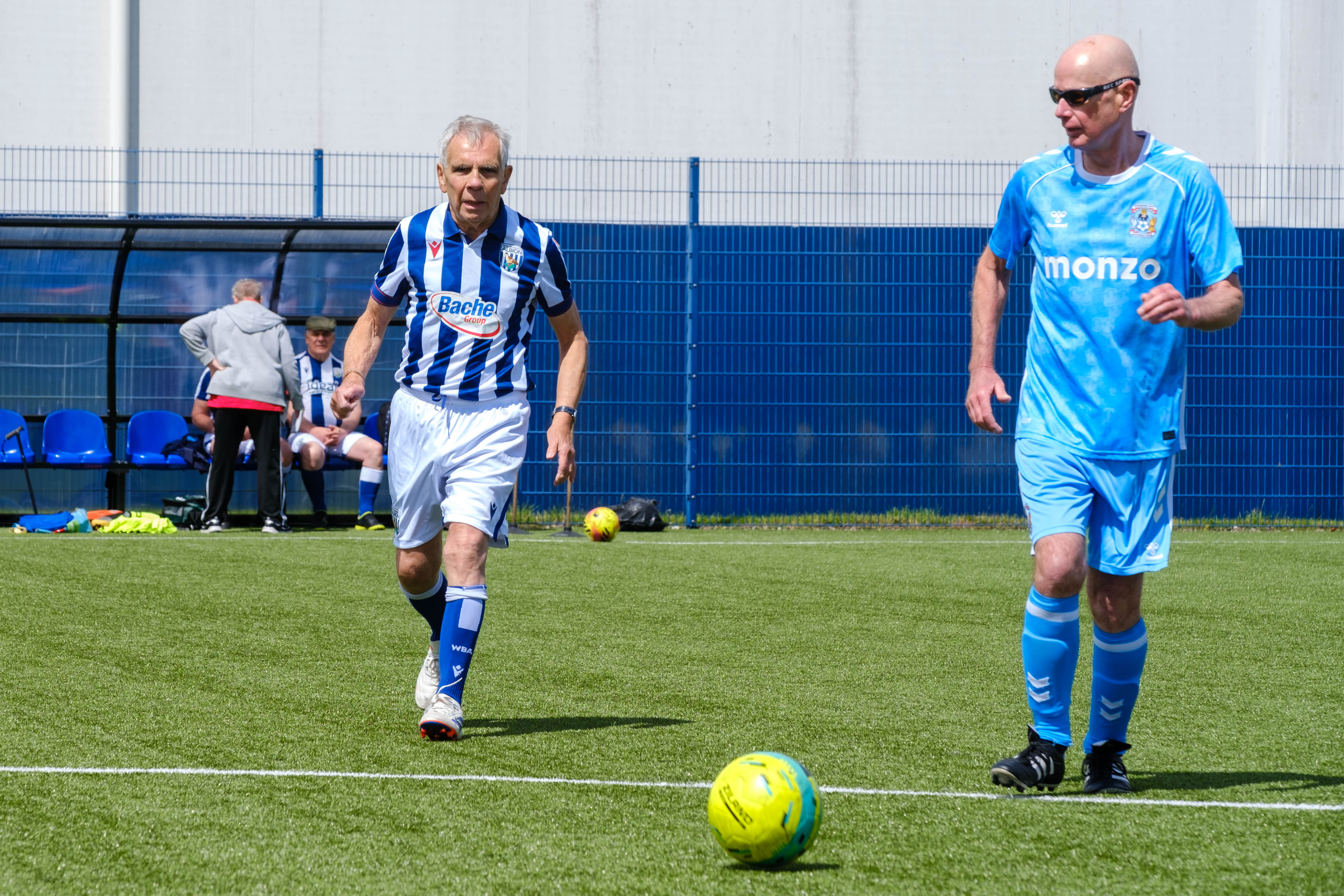 Sky Blue in the Community and Cancer Kickers player chasing the ball.