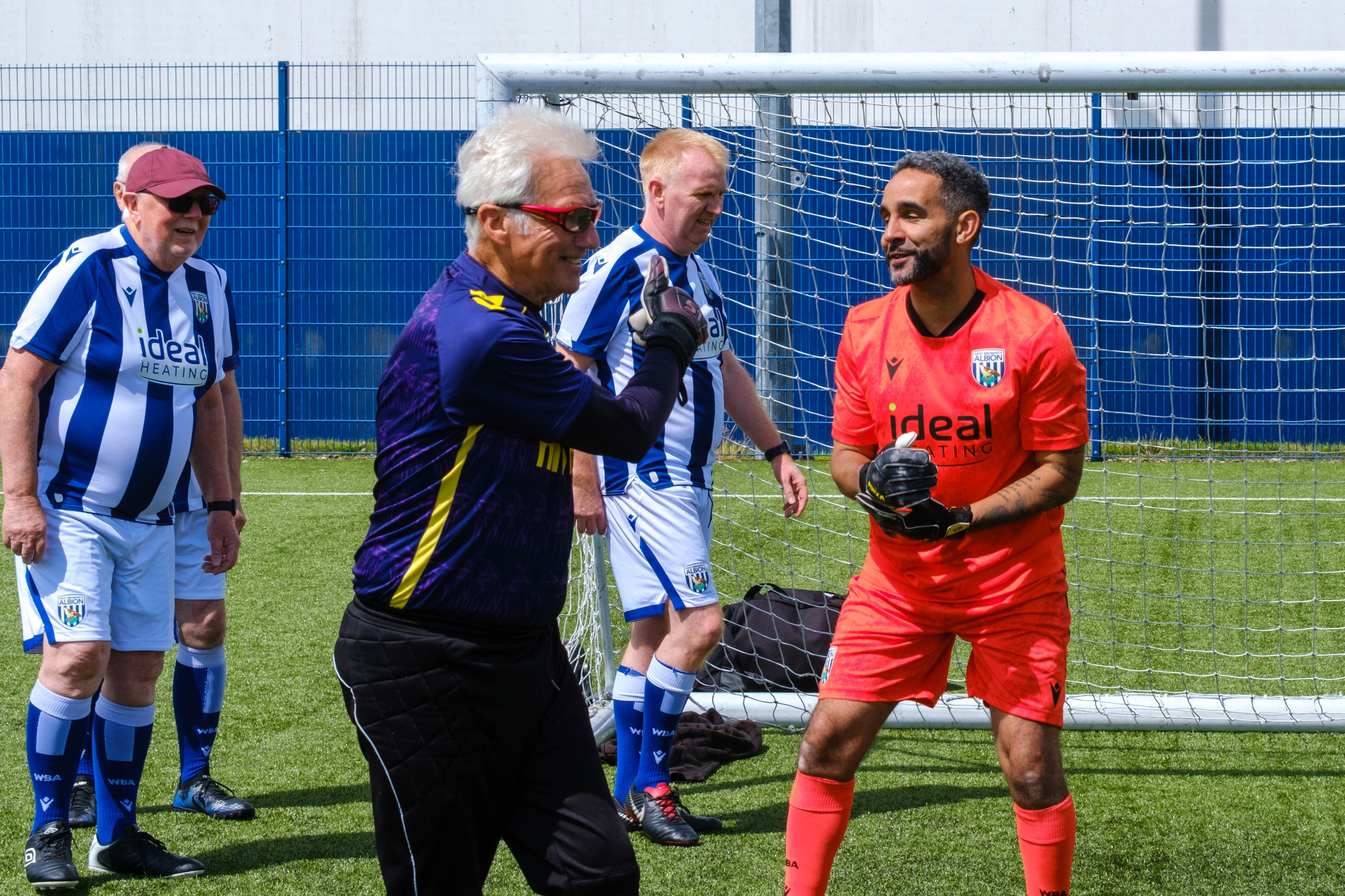 Close-up of Sky Blue in the Community goalkeeper and Cancer Kickers players at the conclusion of the game.