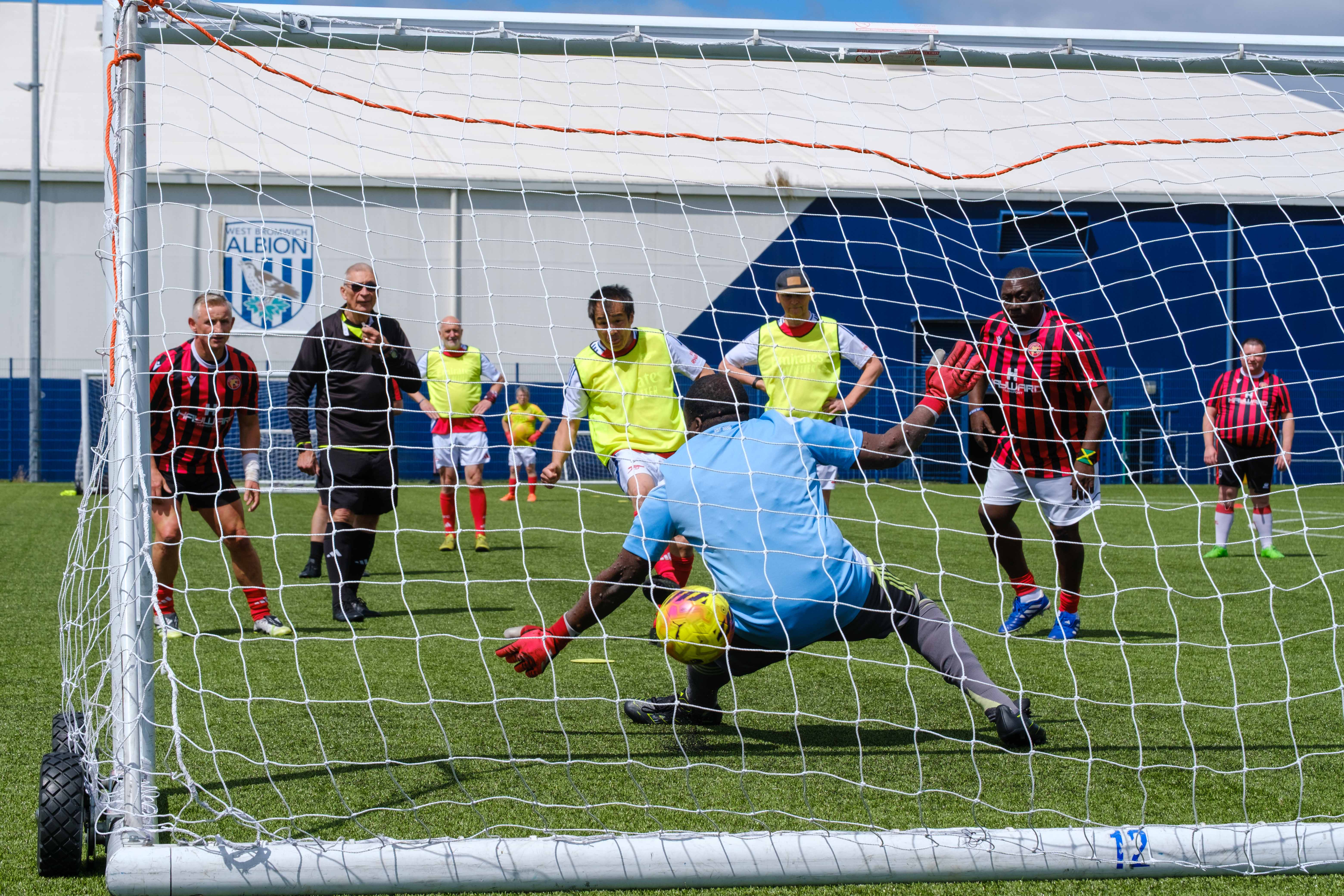 Arsenal penalty hitting the net, beating the Beat the Block keeper from behind the goal.