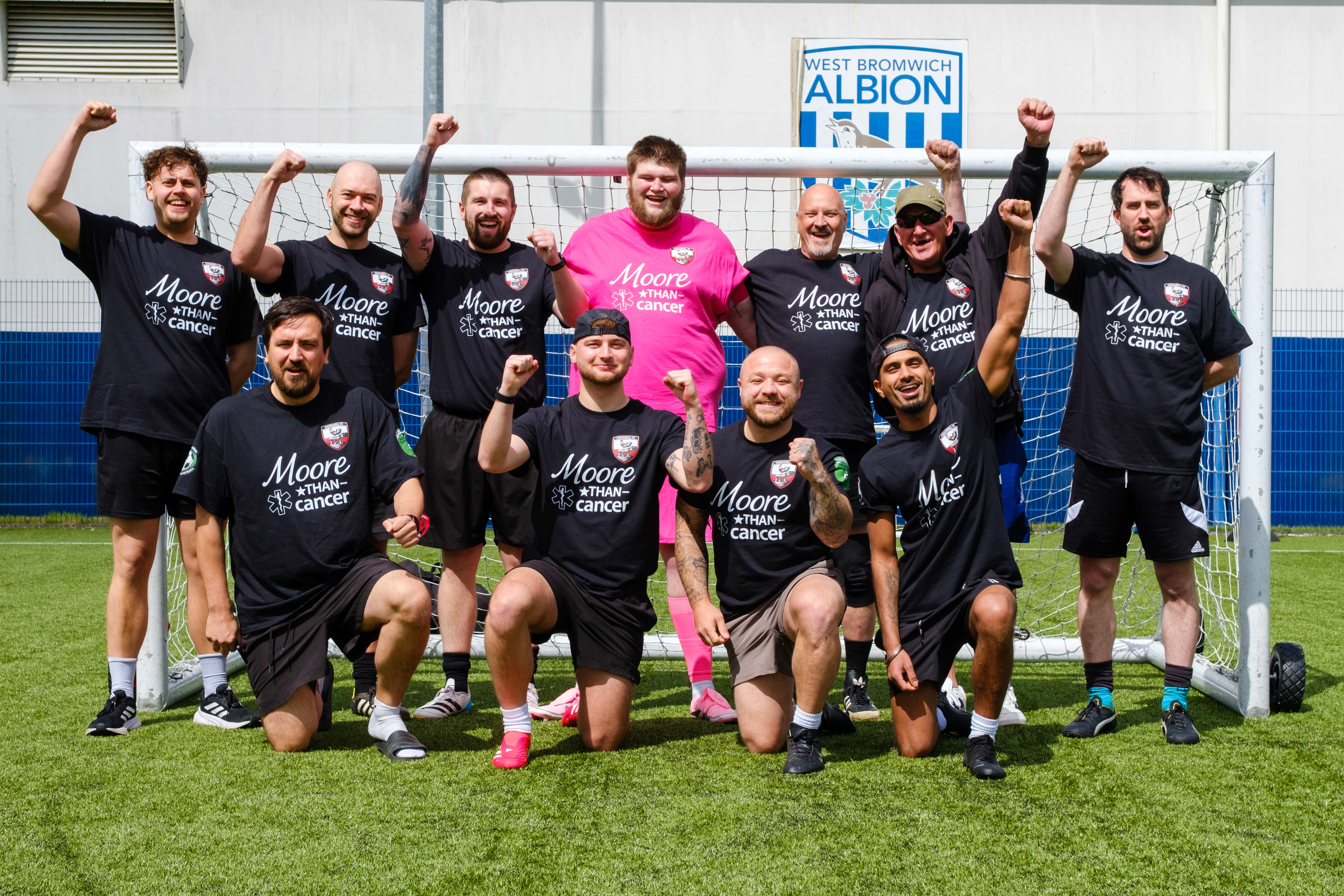 Moore Than Cancer team photo in front of the goal.