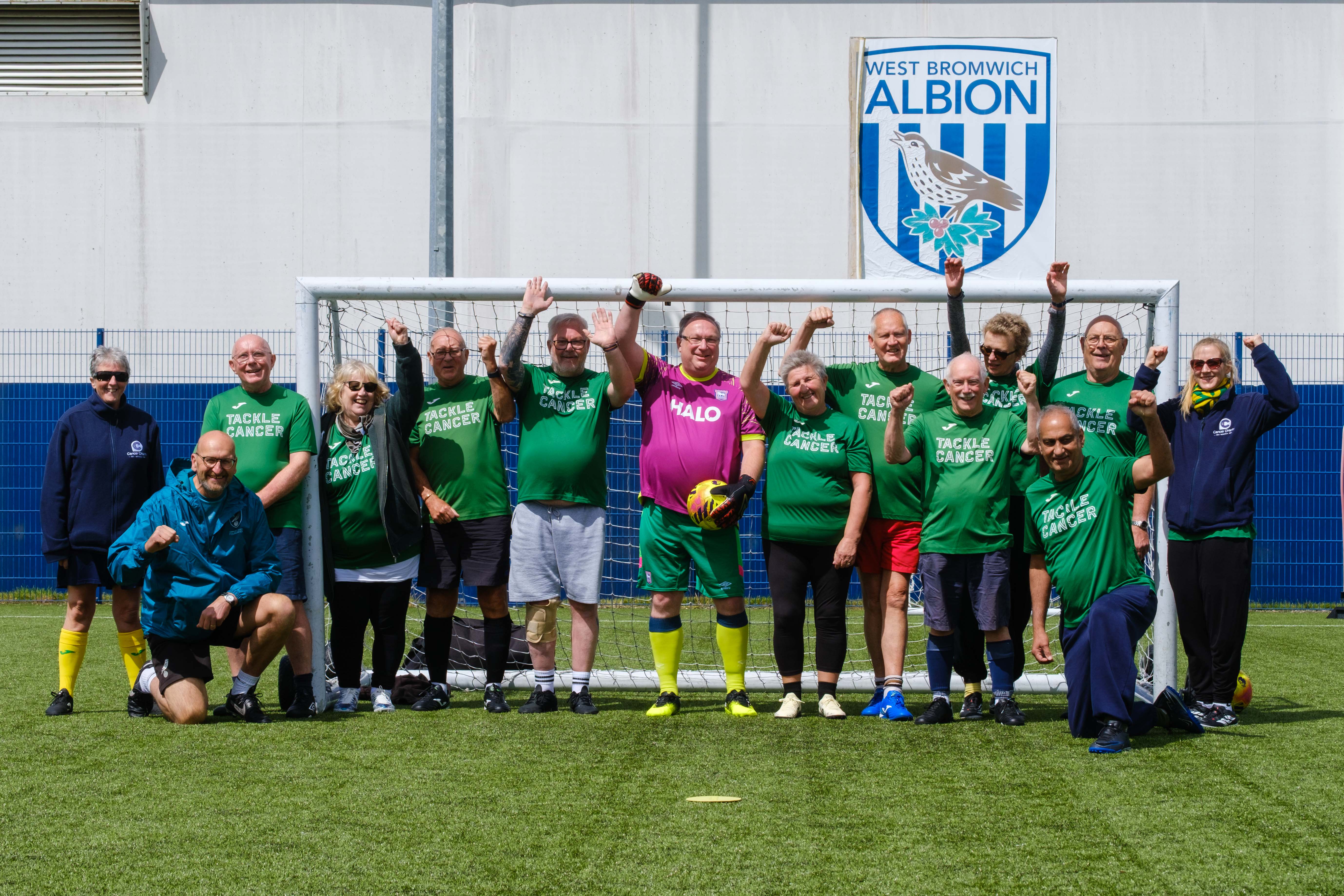 Big C Tackling Cancer (Norwich City Community Sports Foundation) team photo in front of the goal.