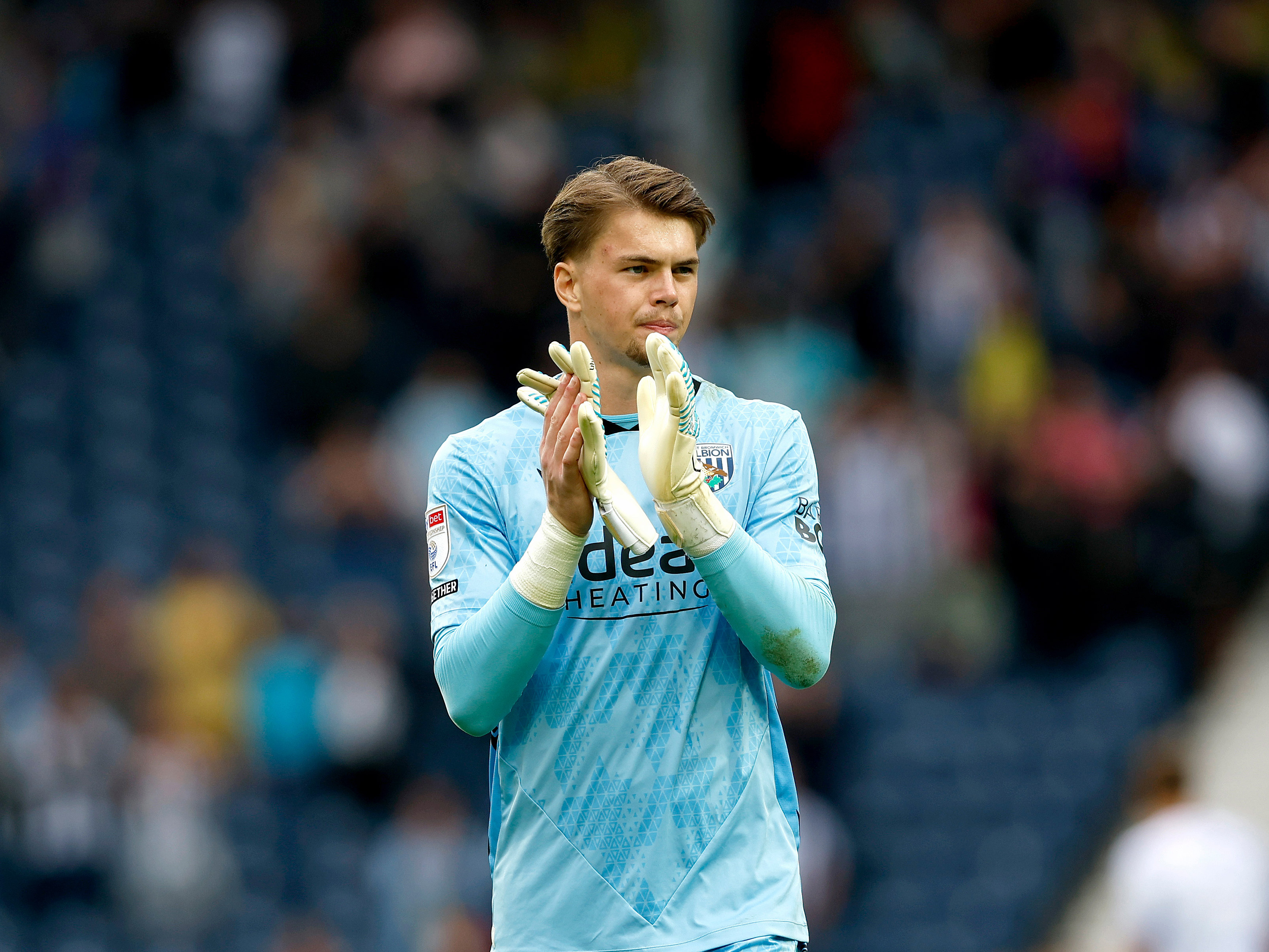 An image of Josh Griffiths applauding Albion fans