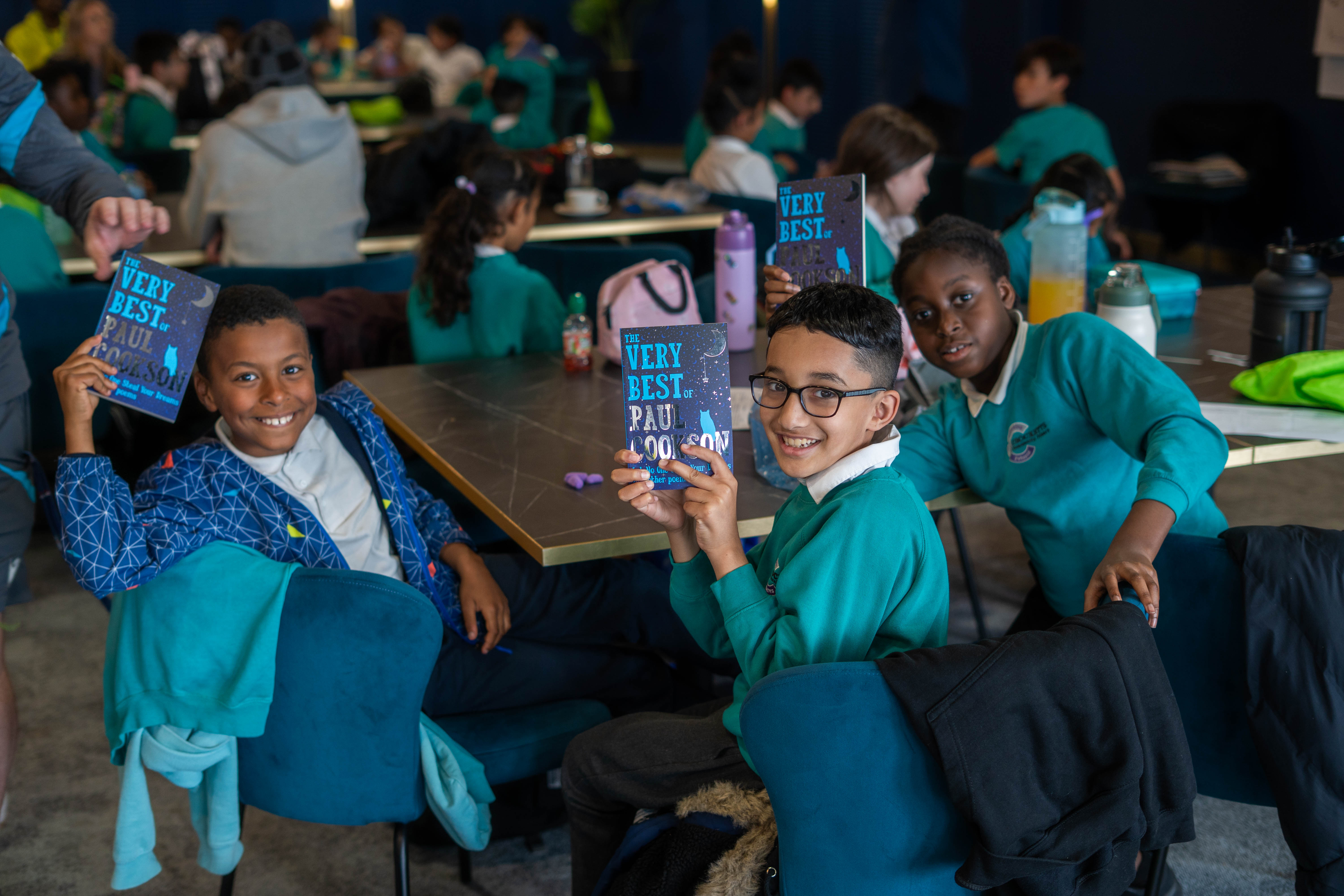 Crocketts Community Primary pupils posing with Paul Cookson's book