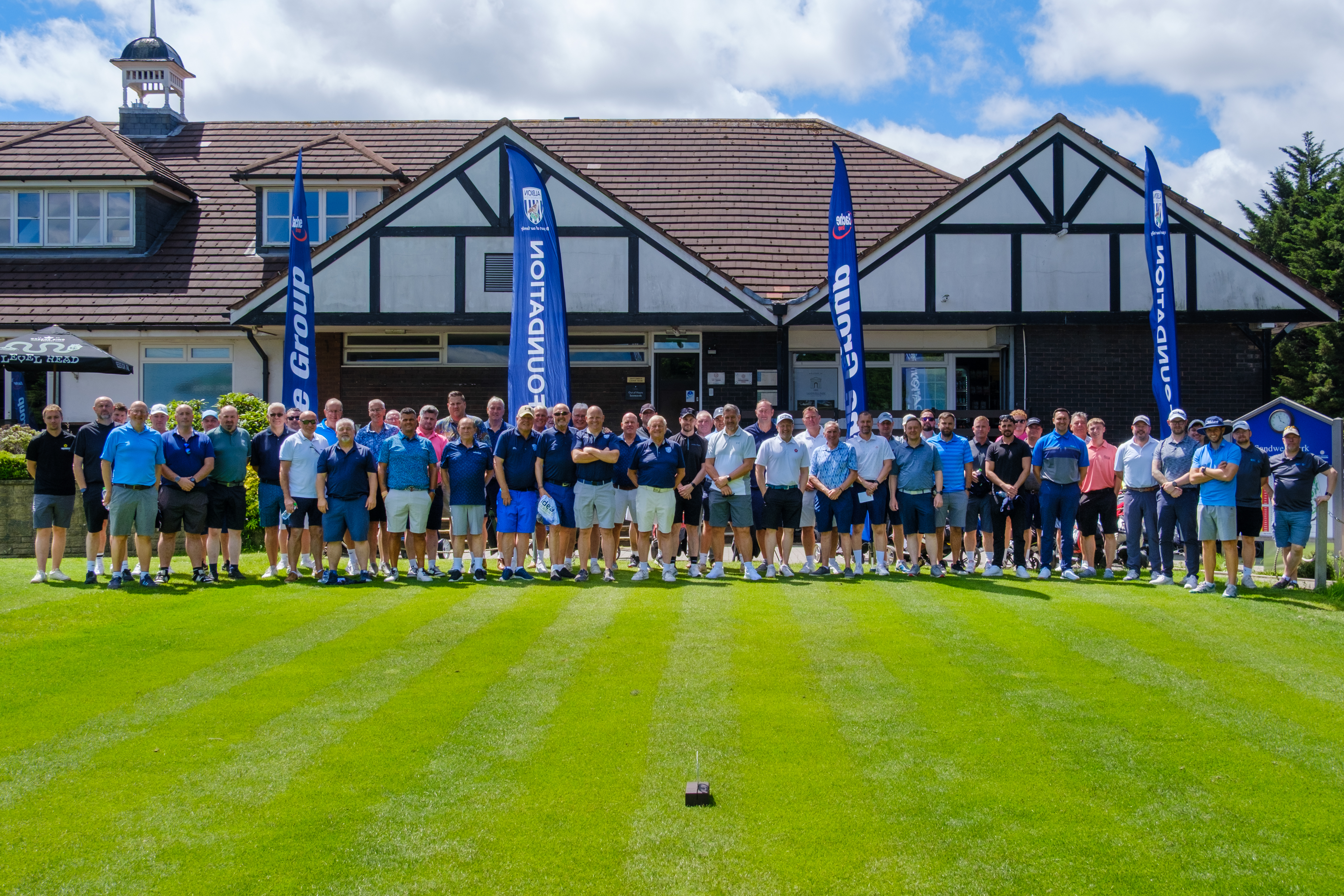 Group photo of all 17 teams posing outside Sandwell Park Golf Club