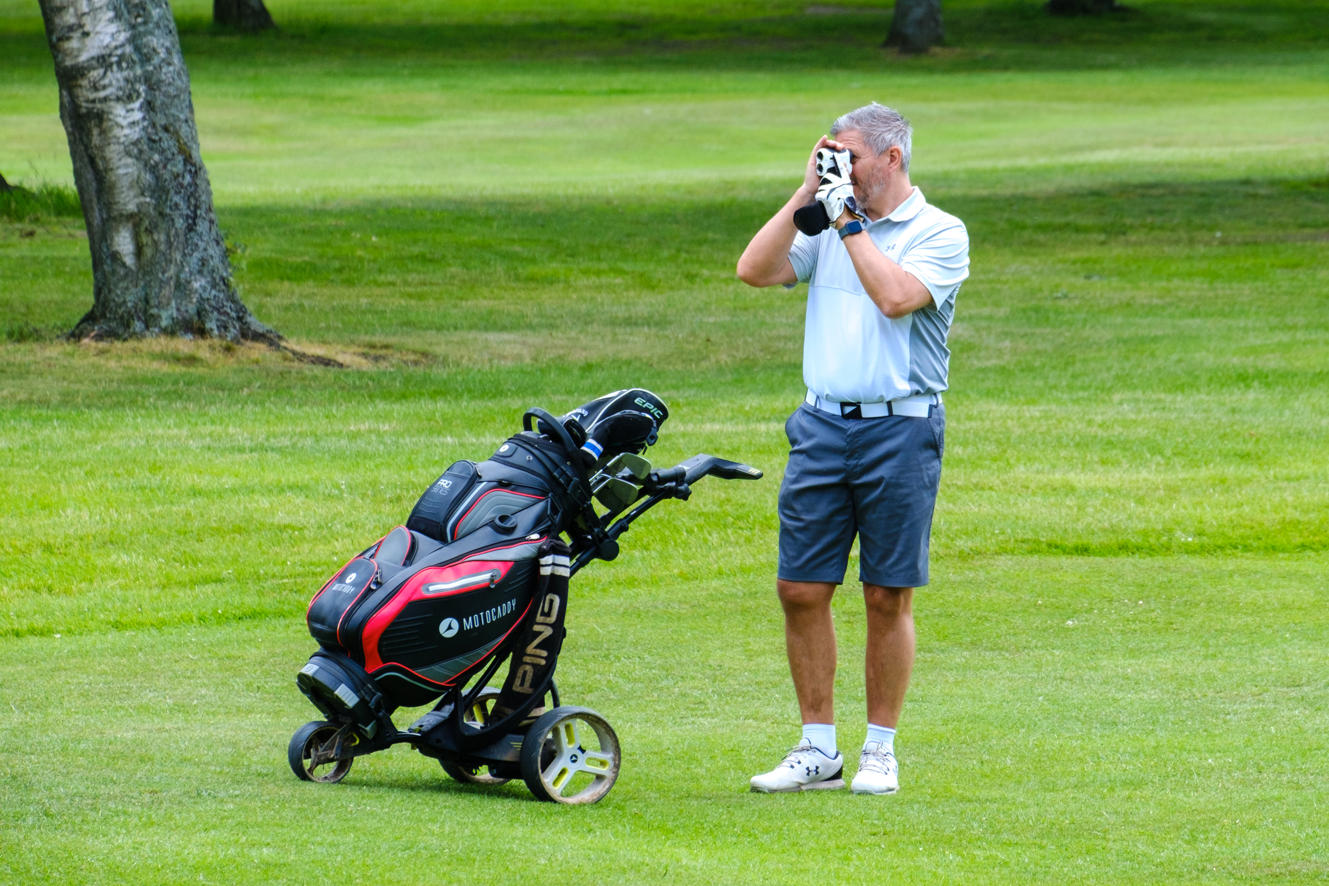 Person on a golf course using a rangefinder