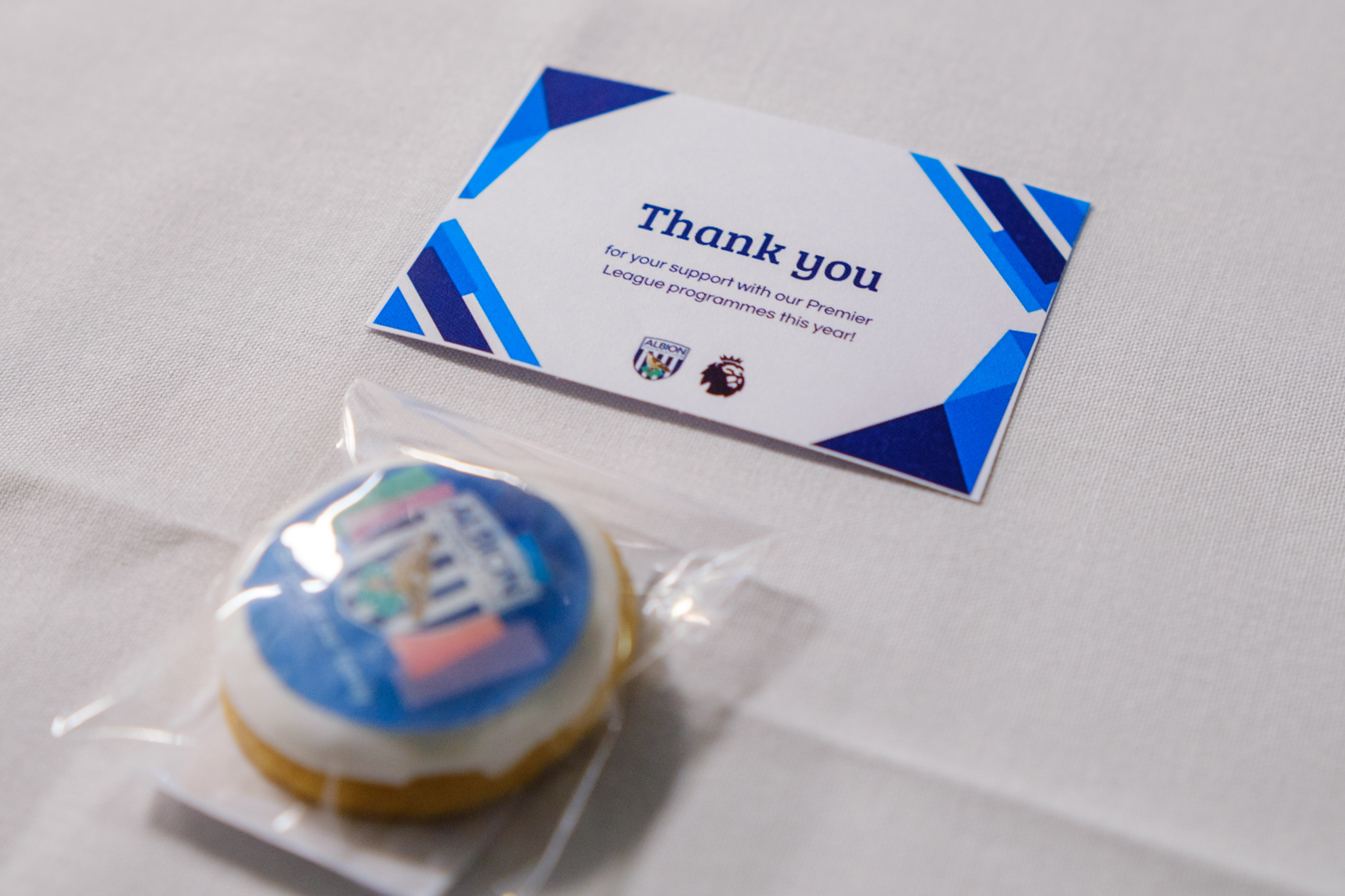 Close-up of Thank You card and Albion Foundation themed biscuit.