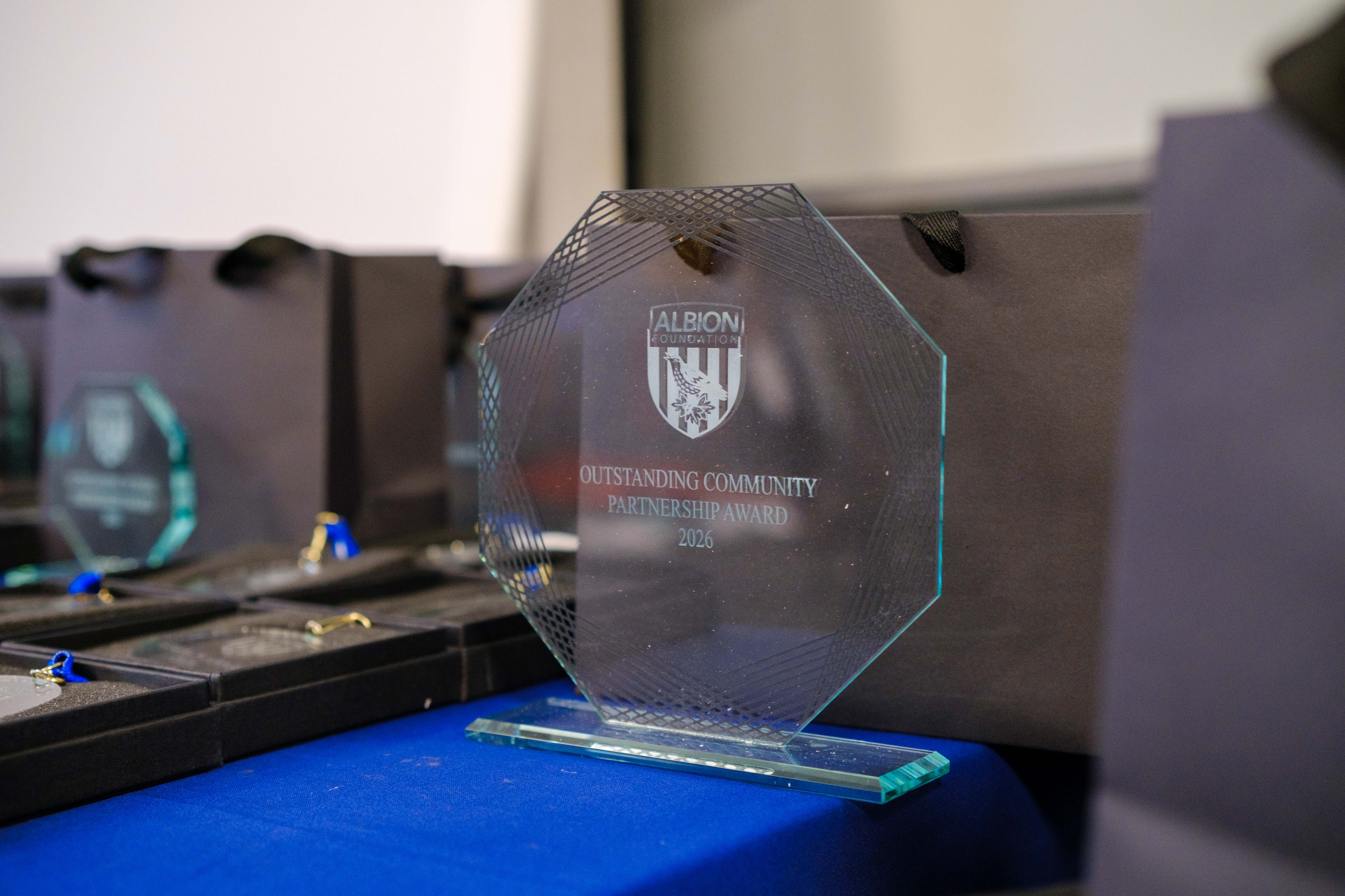 Close-up of Outstanding Community Partnership glass award on the table