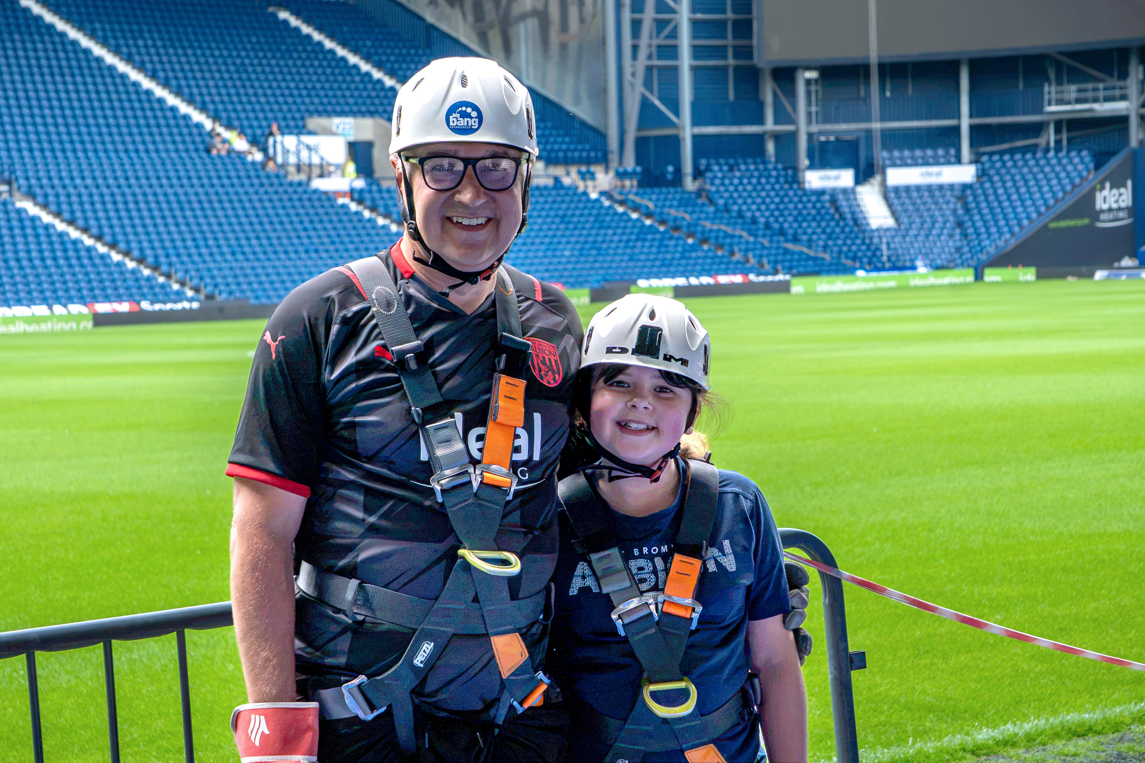 Heidi and Dave standing pitch side after the Abseil.