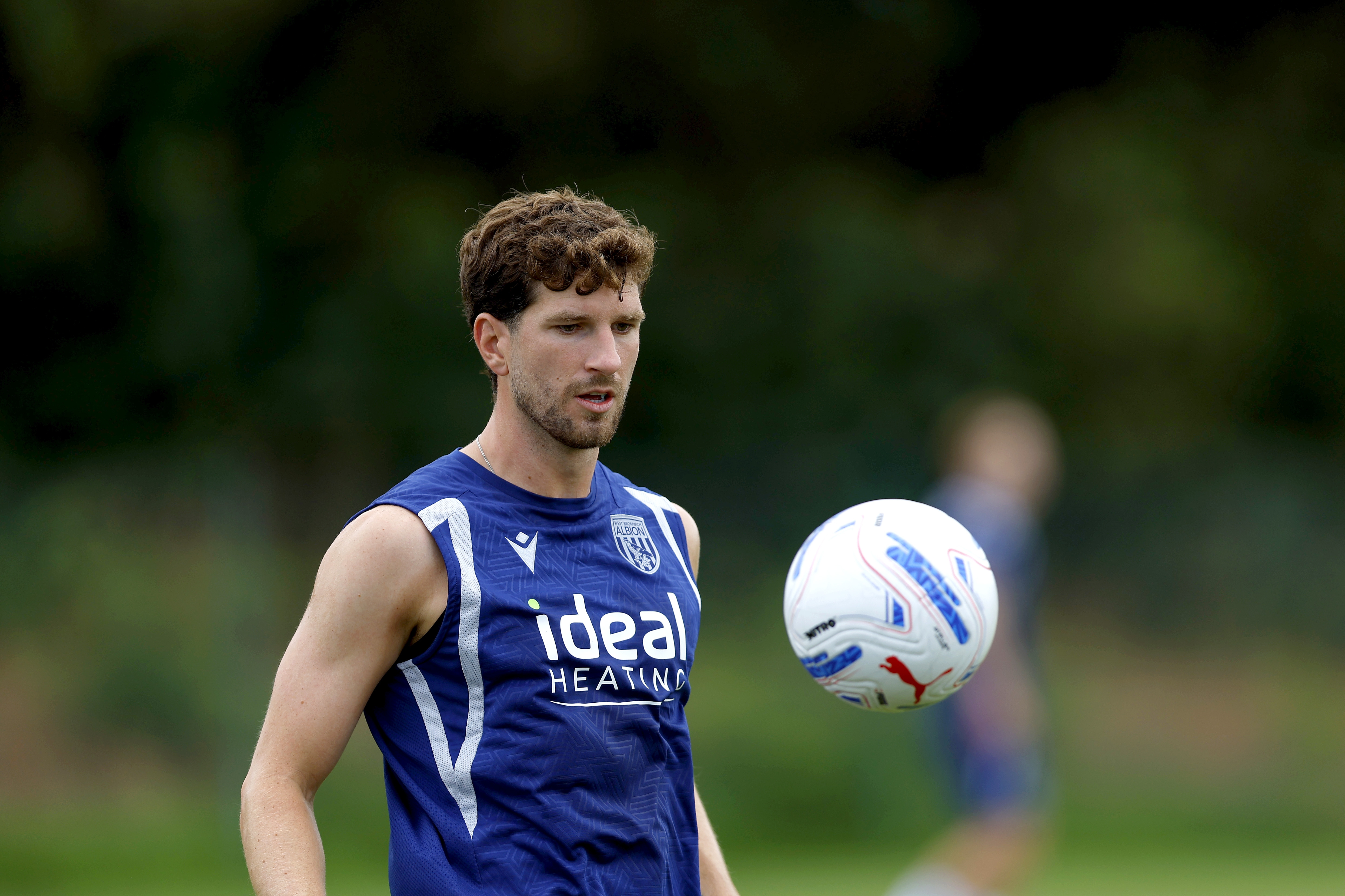 Chris Mepham controls the ball on the training pitch in Portugal.