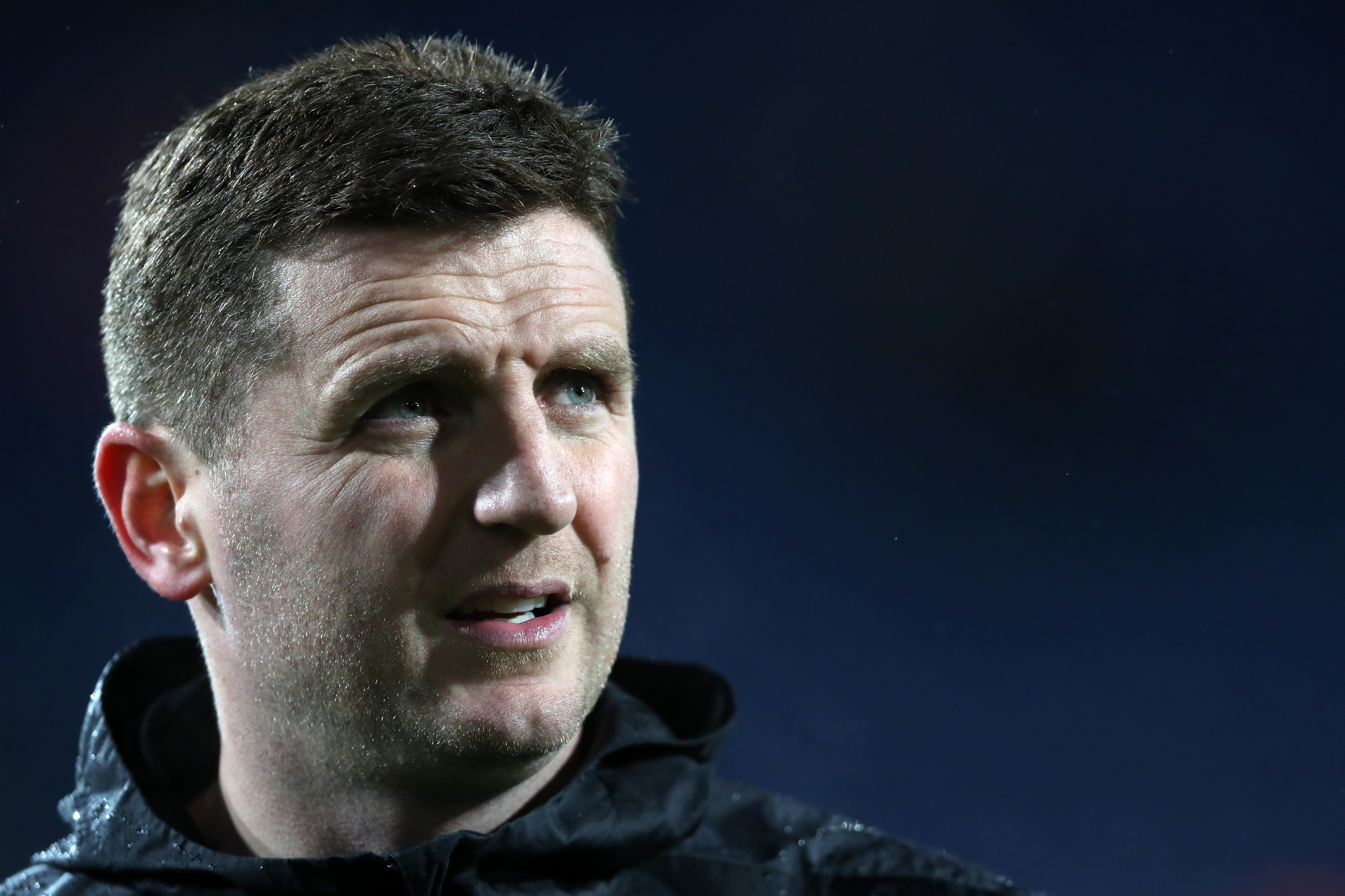 A close-up shot of Alex Bruce's face 