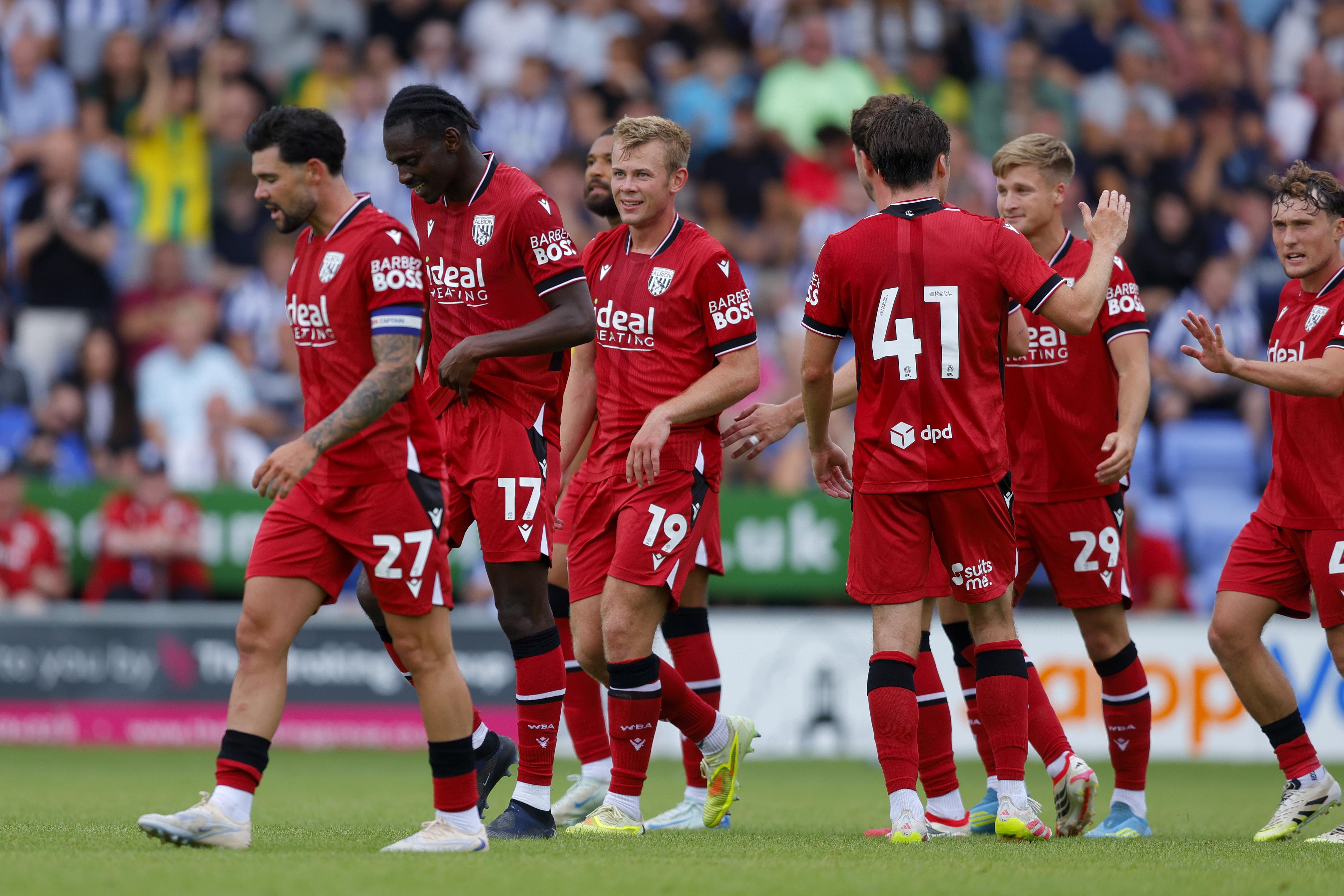 Several WBA players celebrate a goal scored at Shrewsbury Town in a pre-season friendly in the red kit 