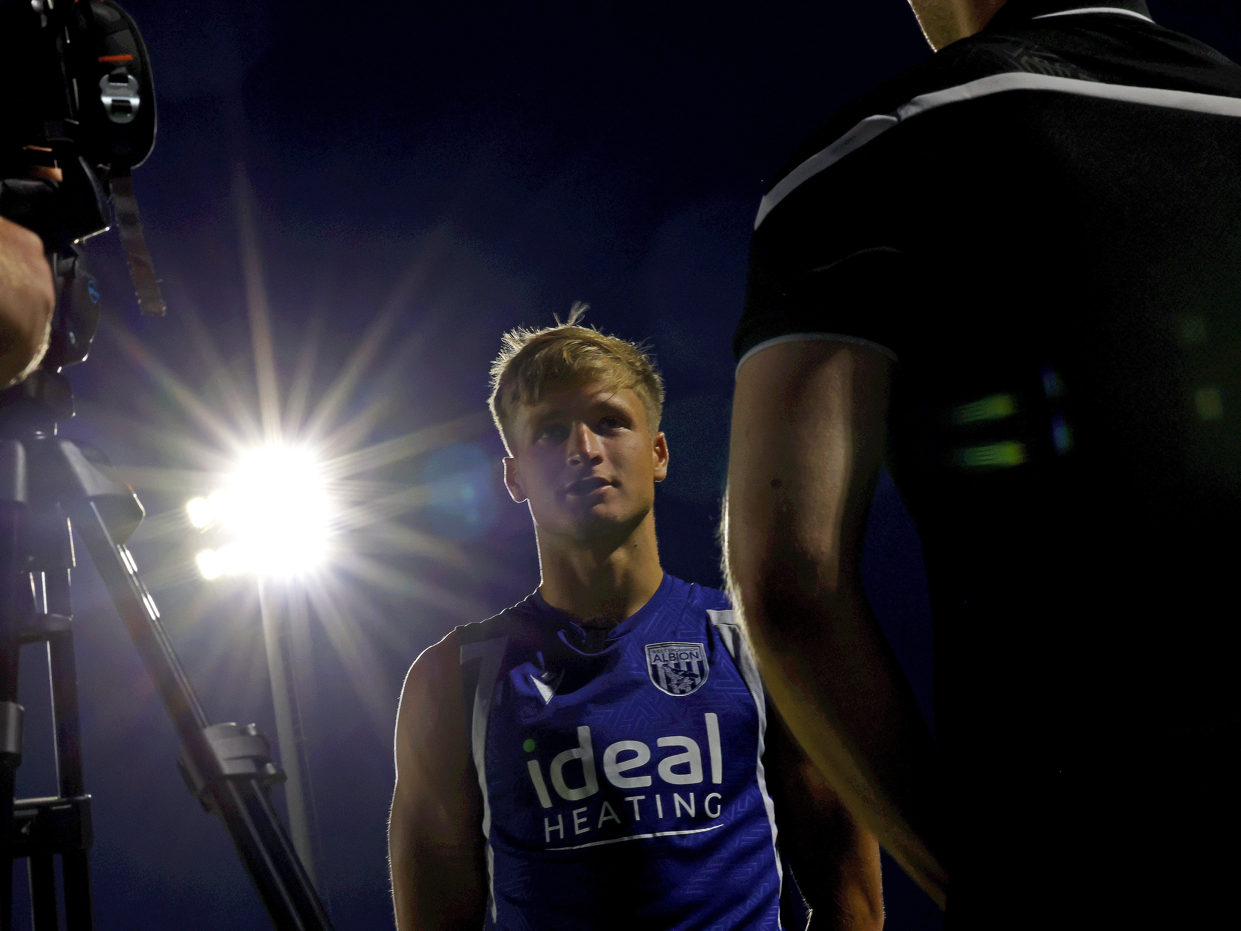 A photo of JJ Morgan speaking to WBA TV following Albion's pre-season match against Bromley