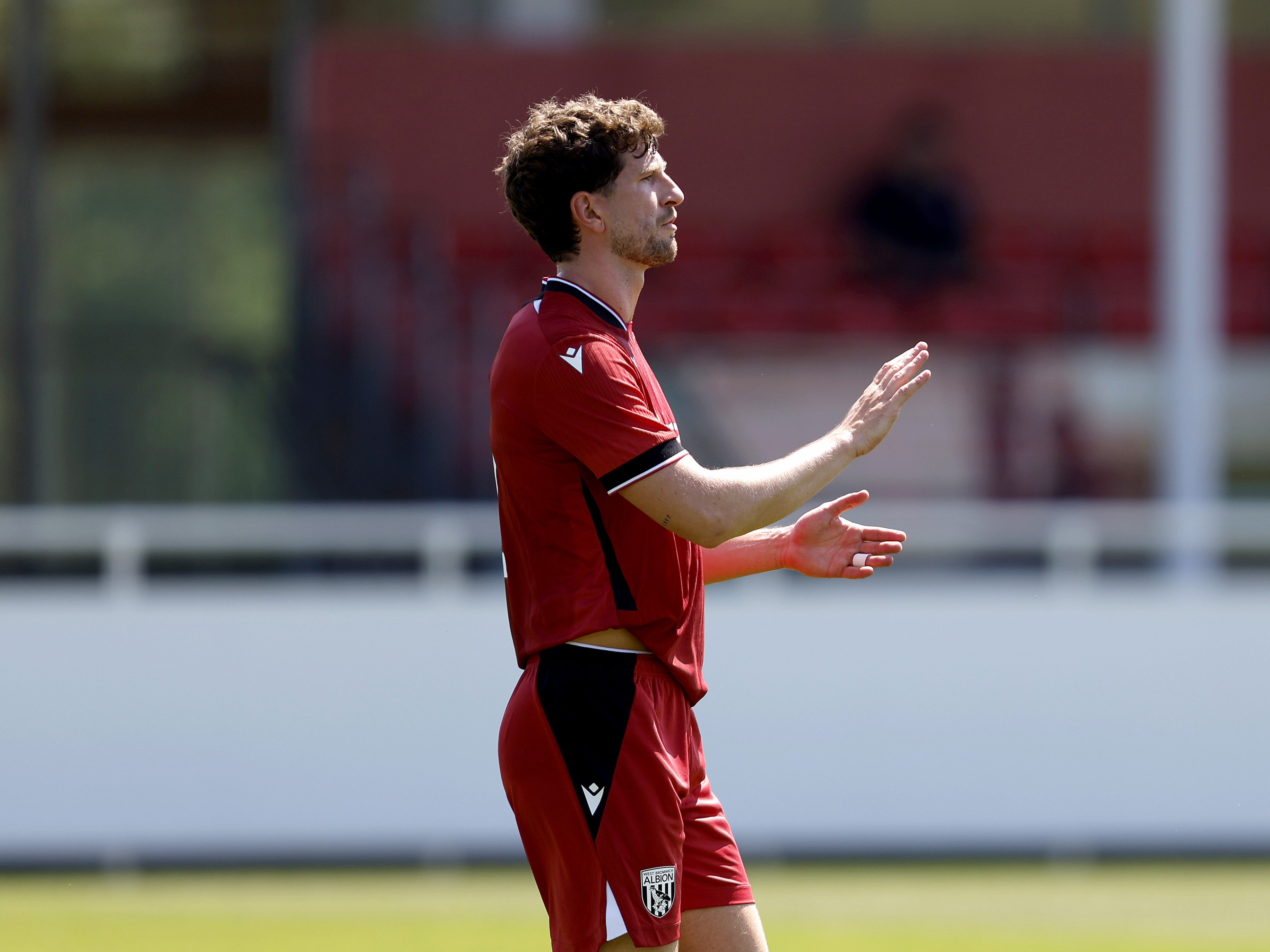 A photo of Chris Mepham in the 2026/27 red away kit