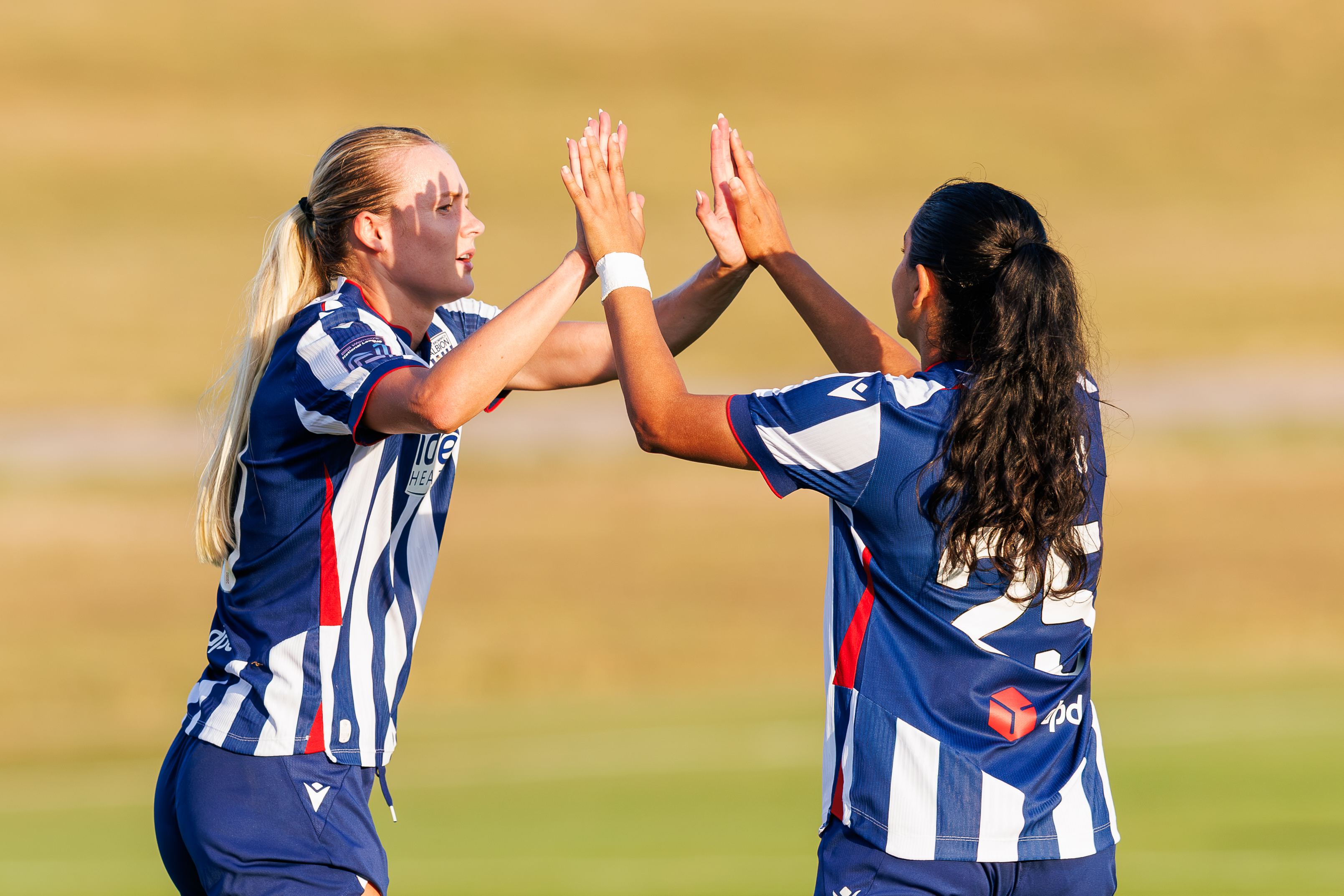 Abbey Jones and Riya Mannu celebrating.