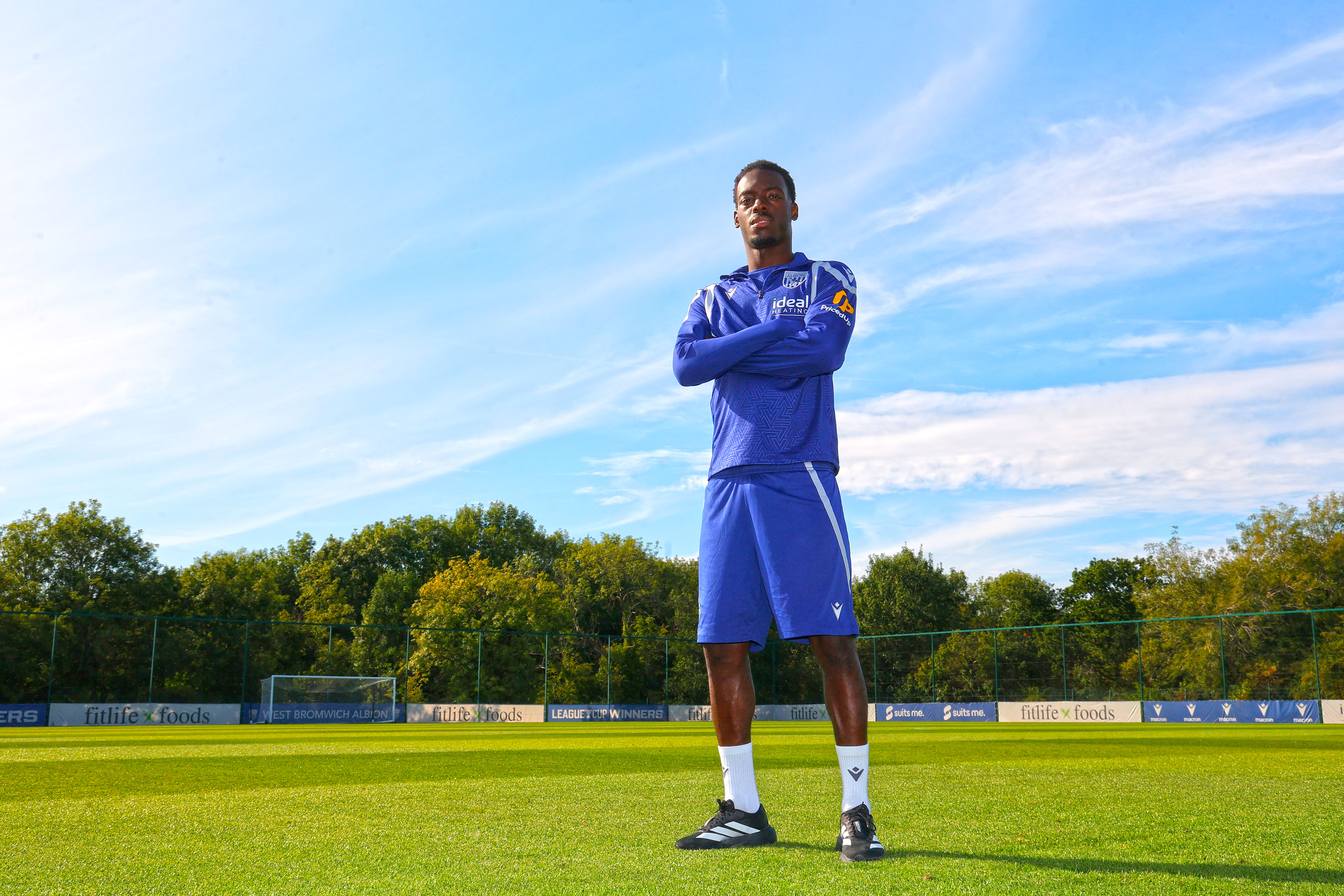 Rabby Nzingoula poses with his arms folded on the training pitch
