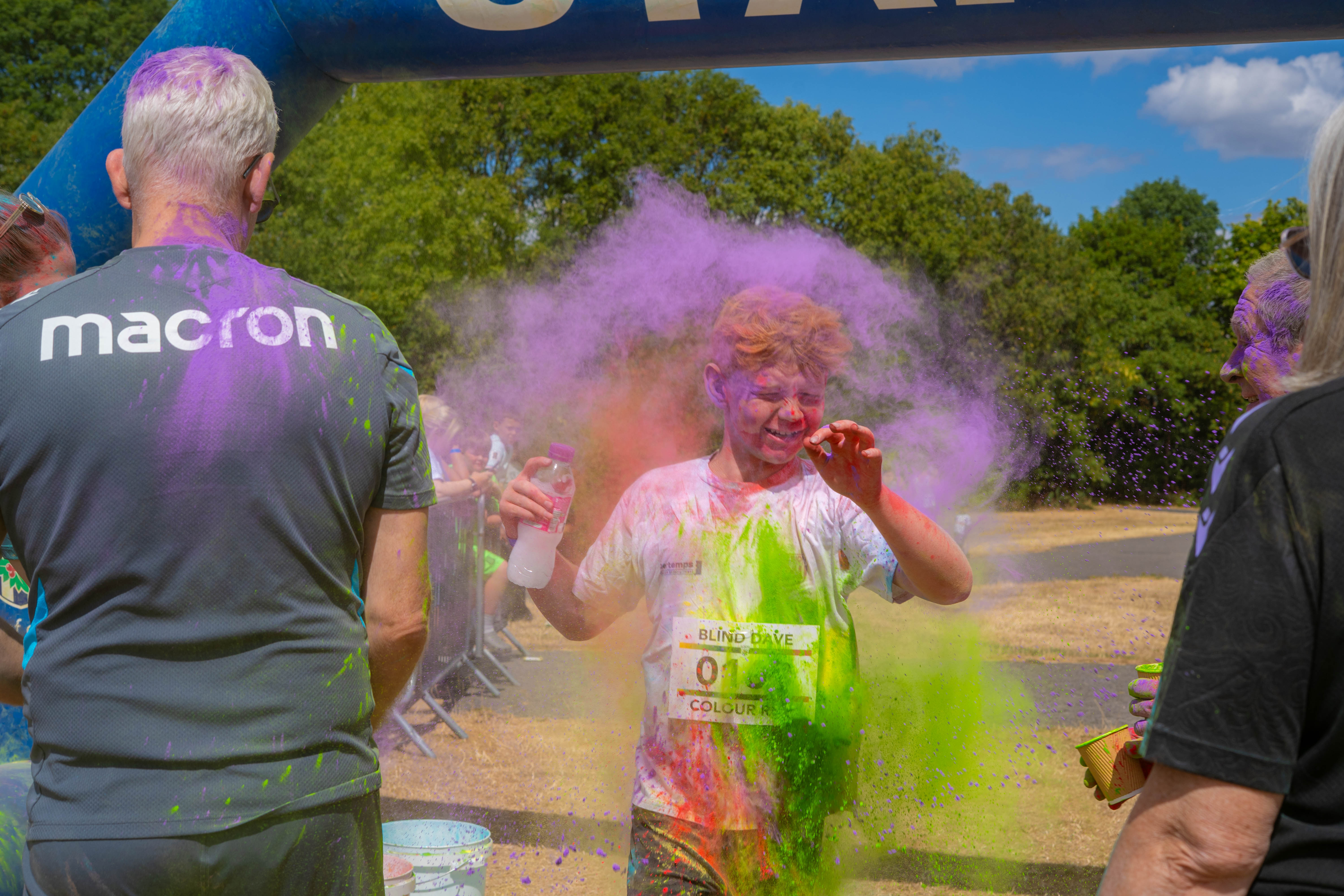 Participant covered in coloured powder during the colour run.