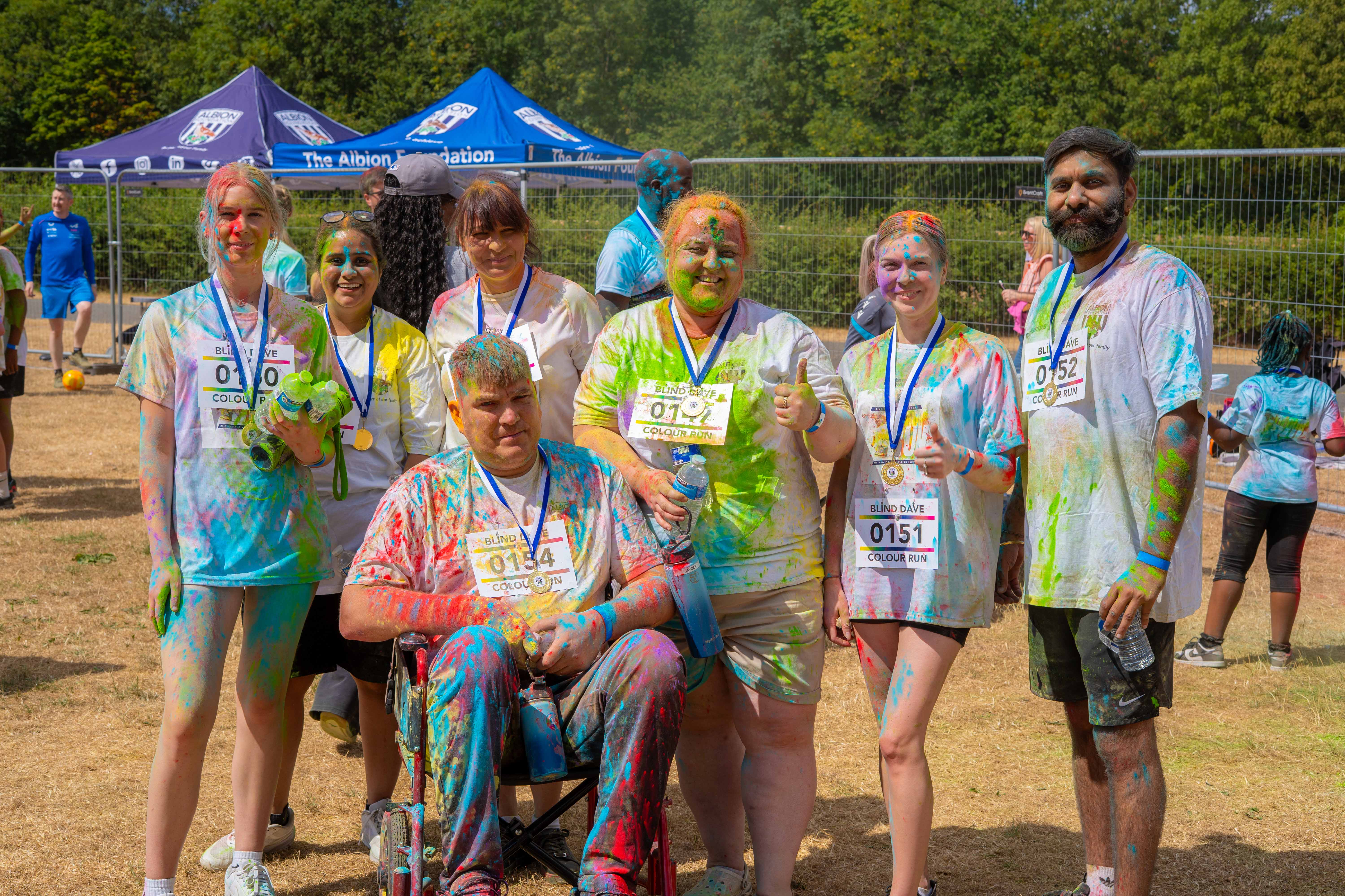 Group of colour run participants posing together after the event.