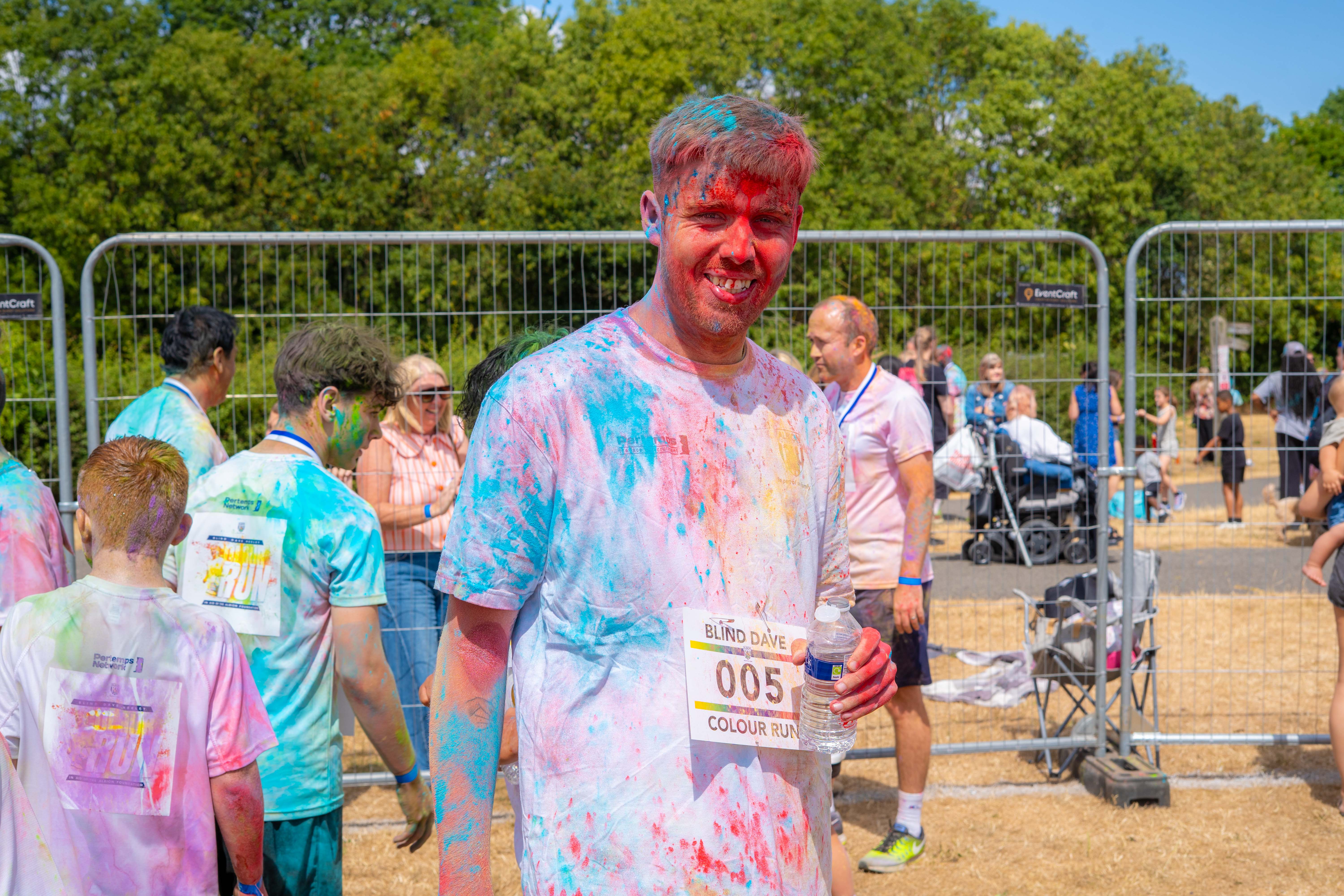 Participant posing for a photo covered in paint.