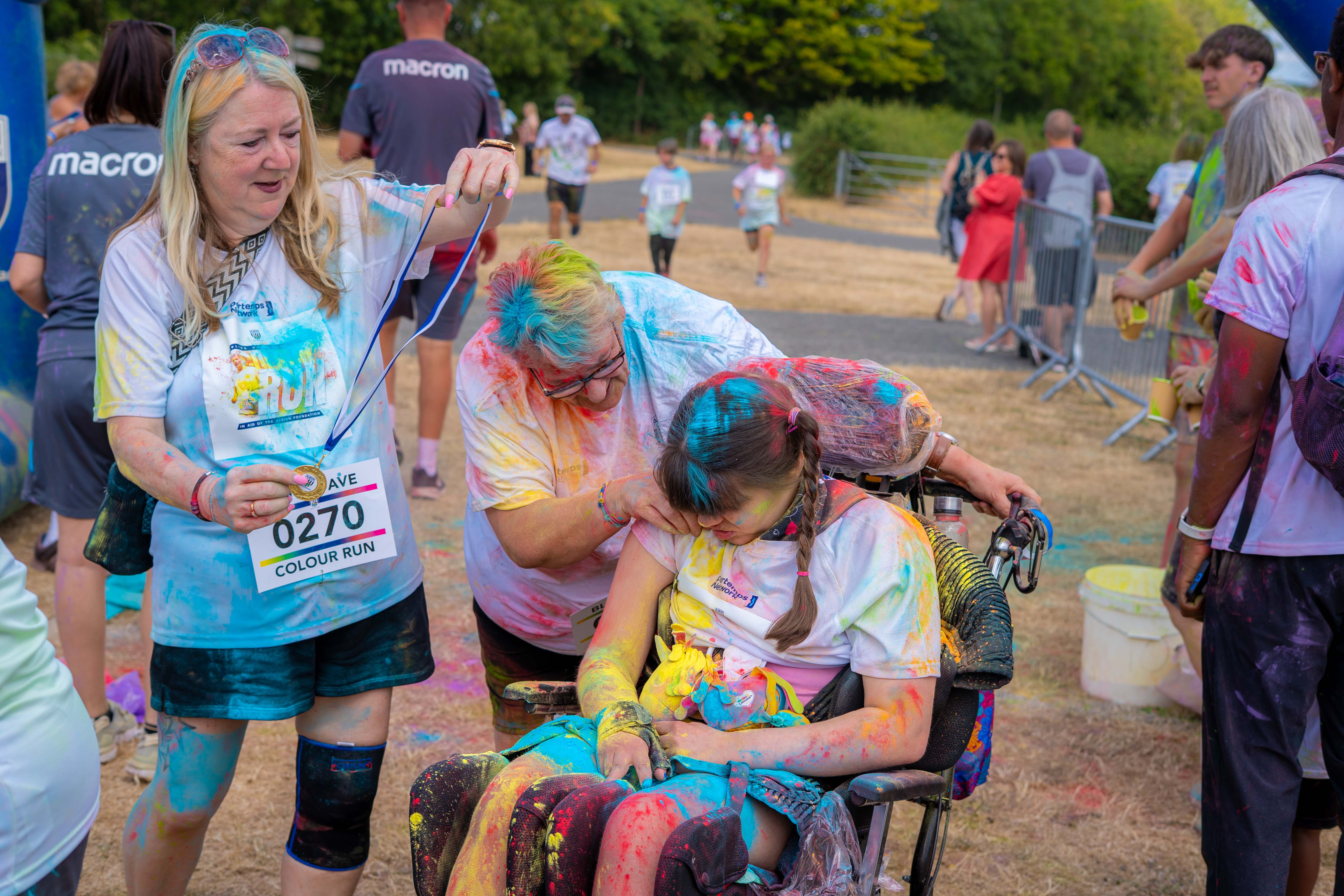 Group gathered around a wheelchair user after the event.