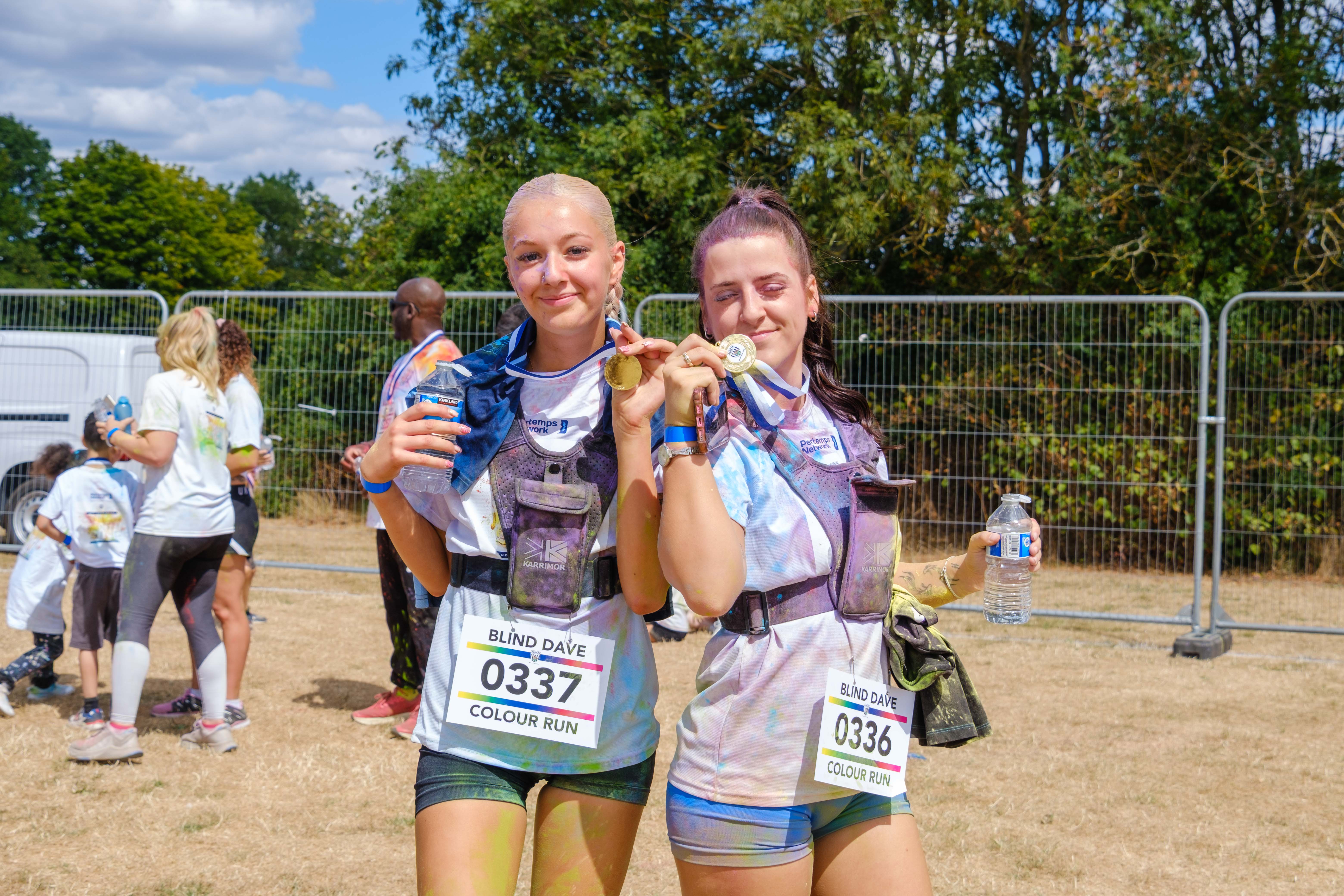 Two participants posing with finisher medals.