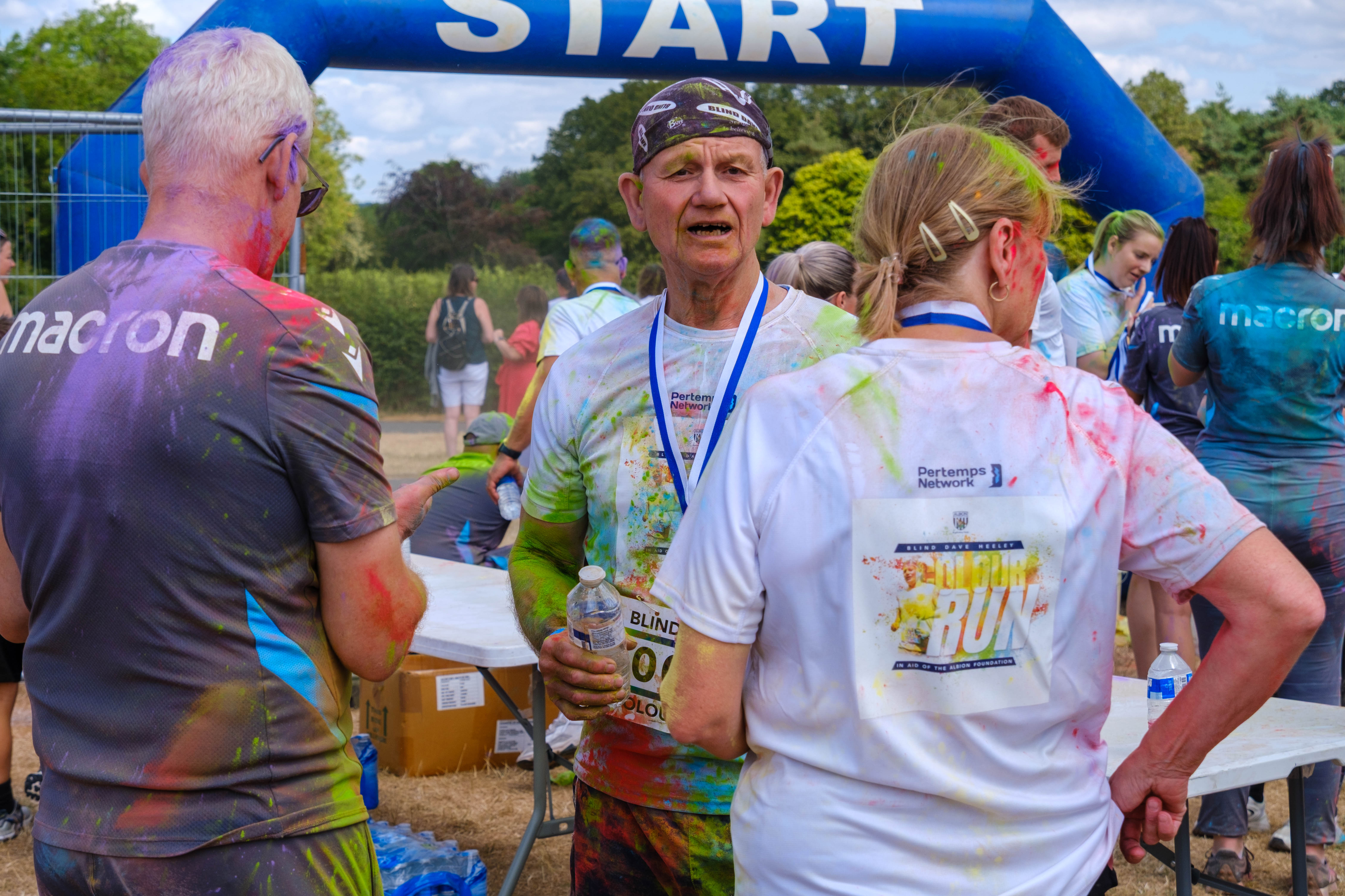 Participants gathering near the FINISH arch after finishing.