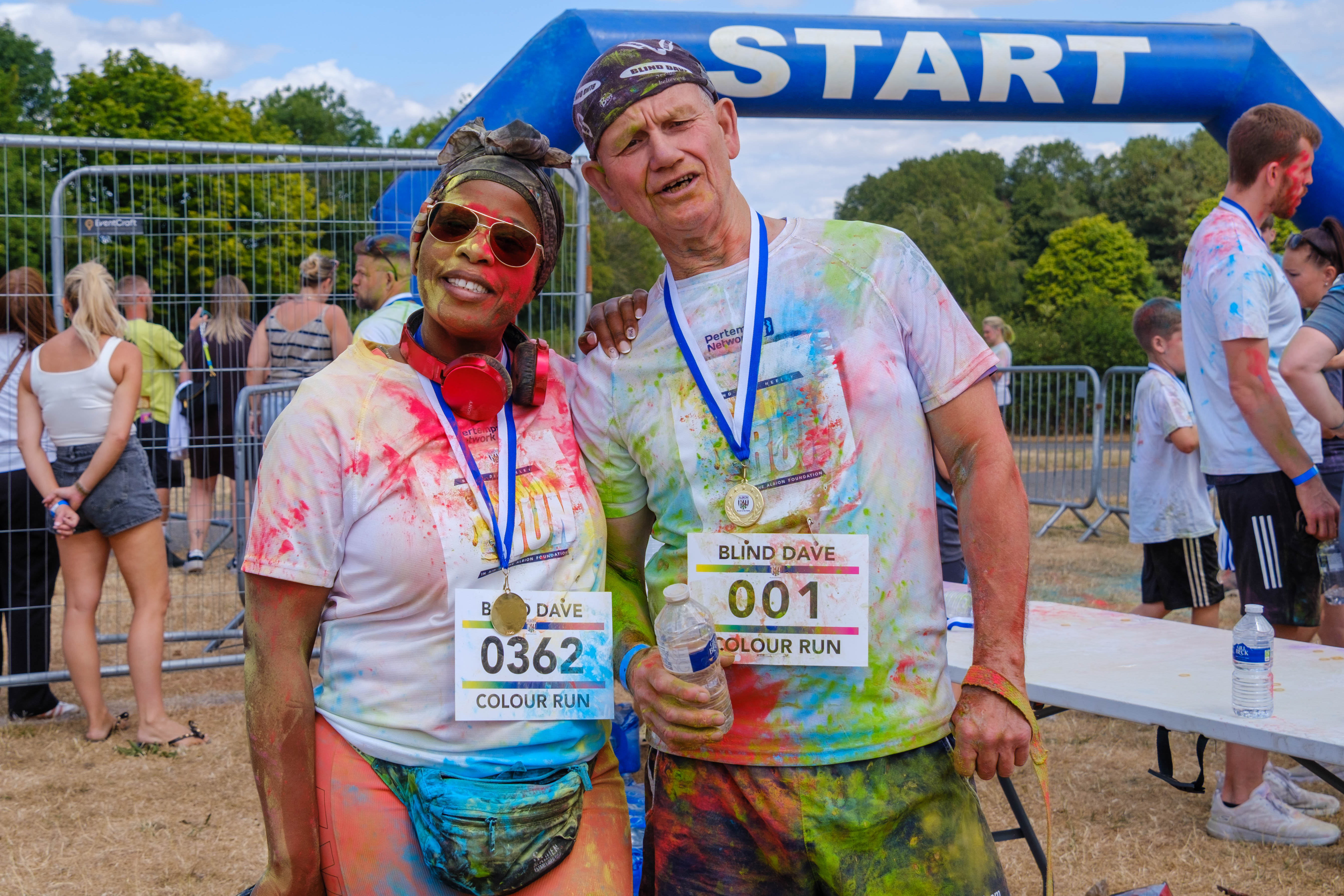 Blind Dave and participant posing for a photo after the Colour Run.