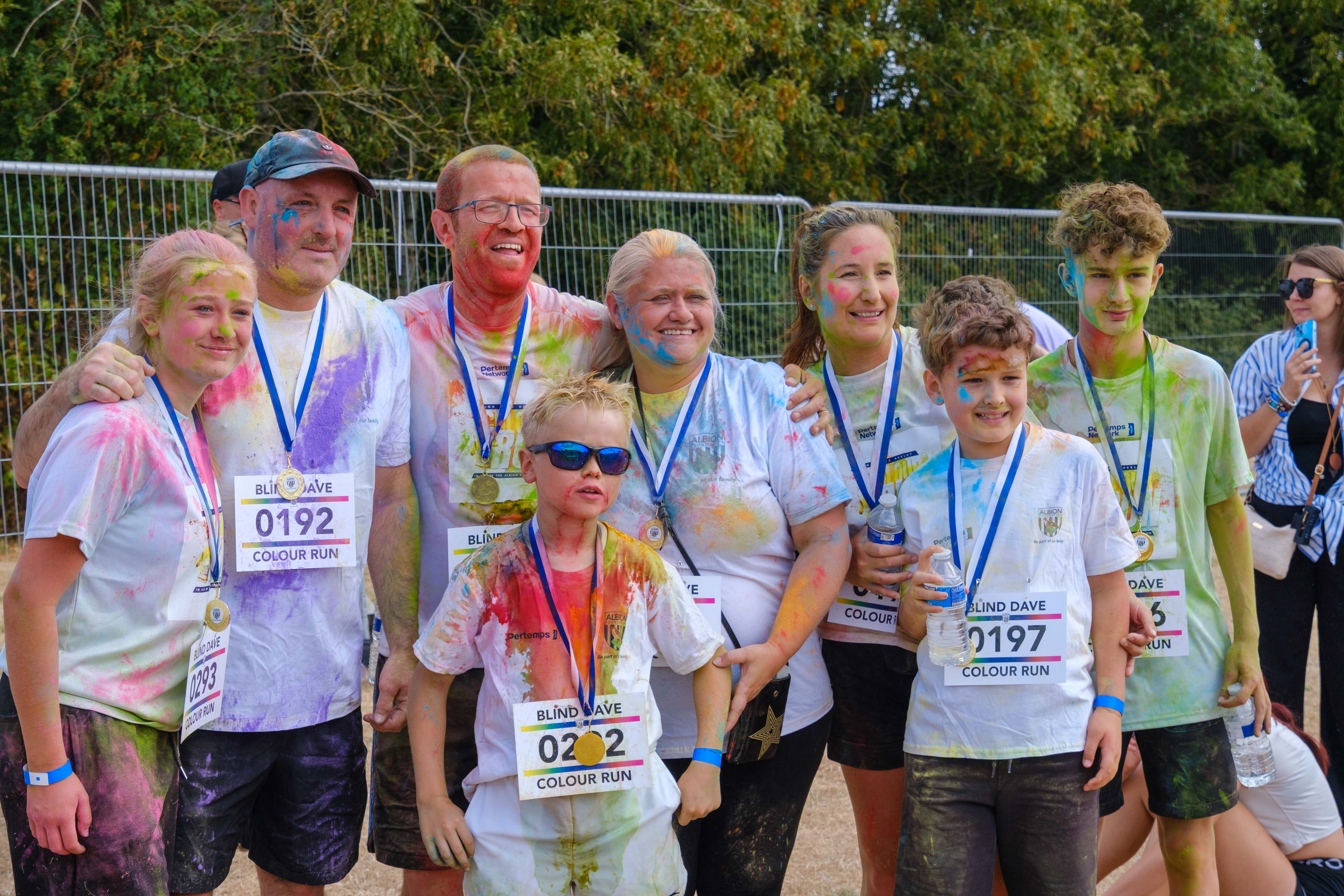 Group of participants posing with medals.