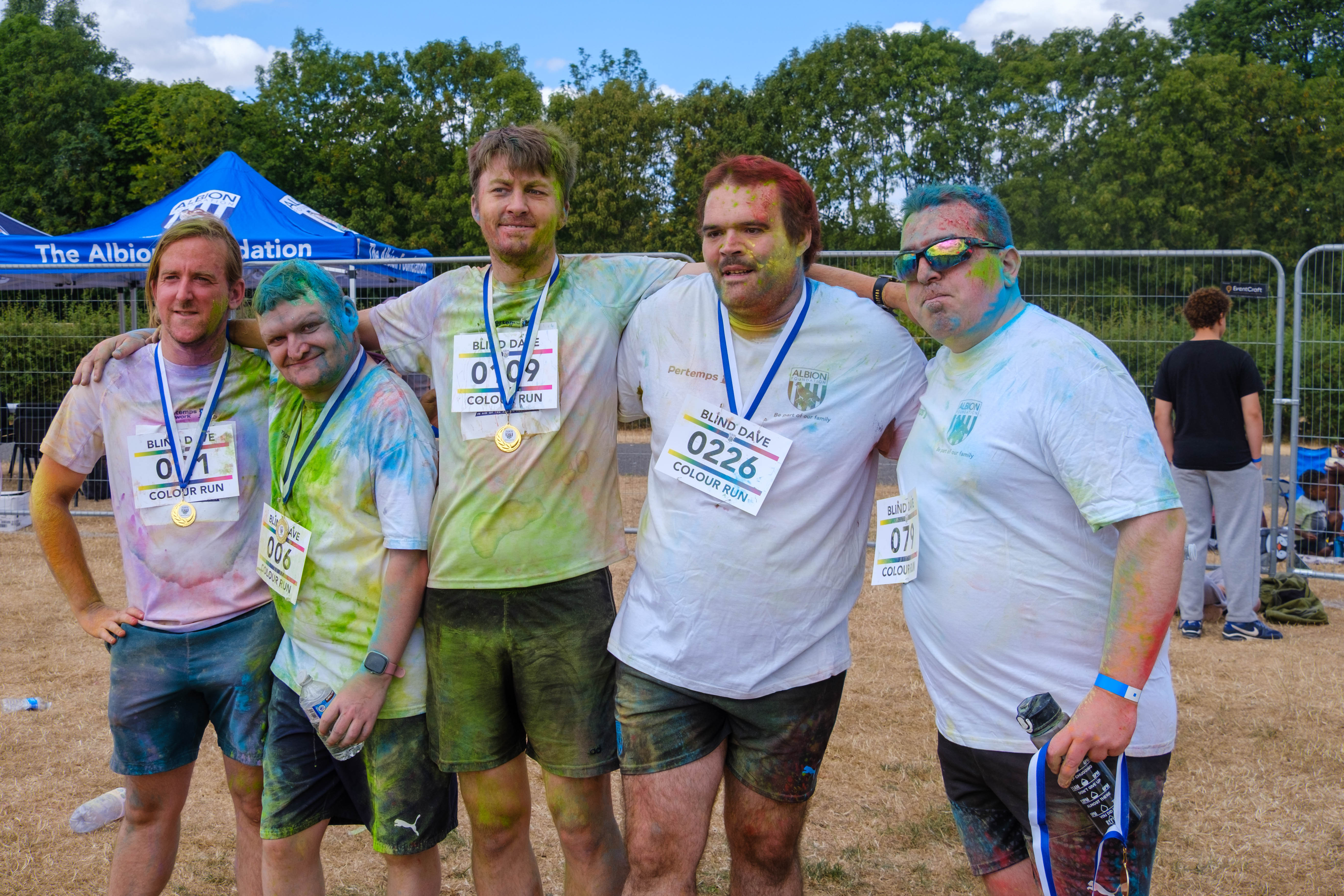 Group of participants posing with medals.
