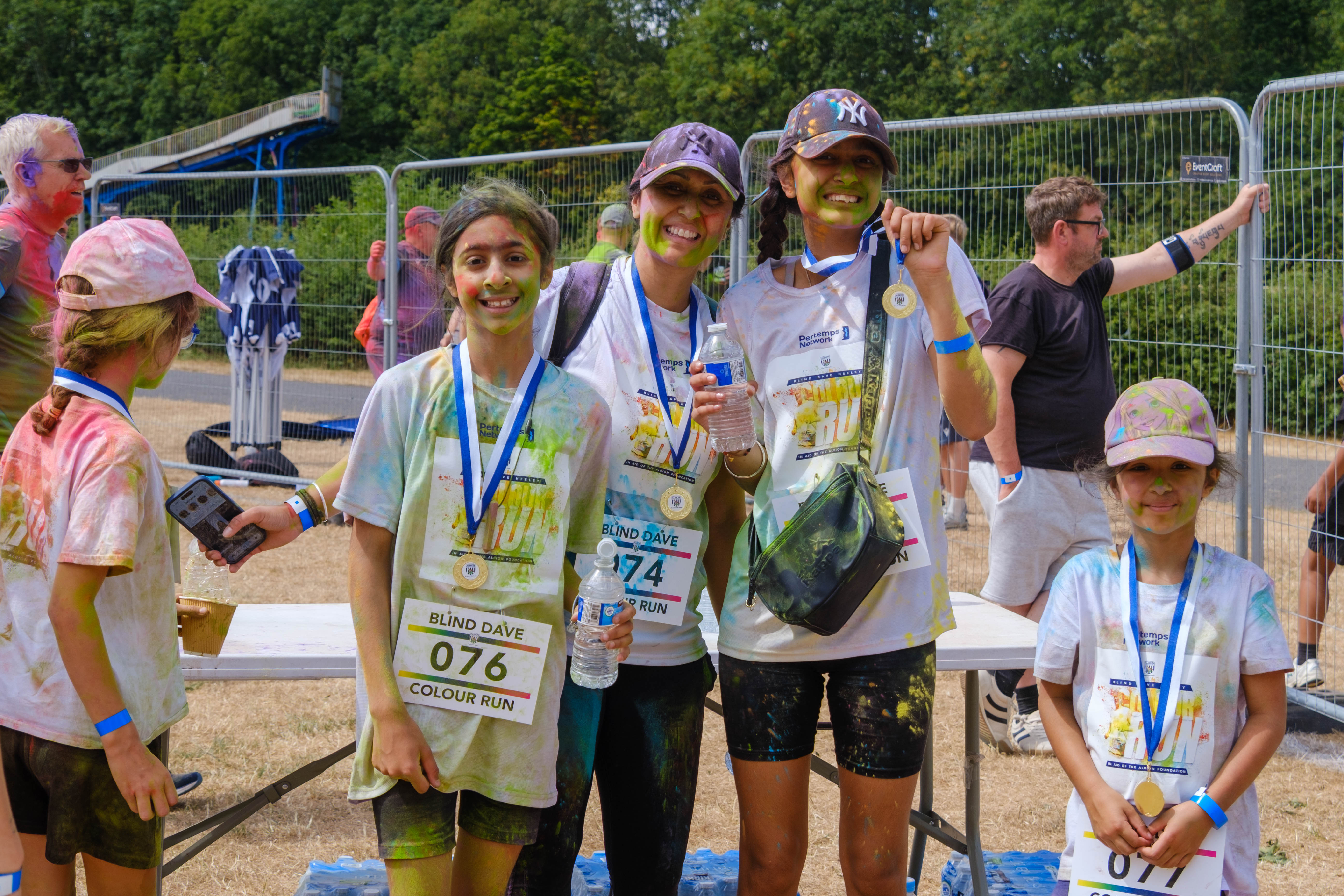 Group of posing for a photo next to the FINISH area.