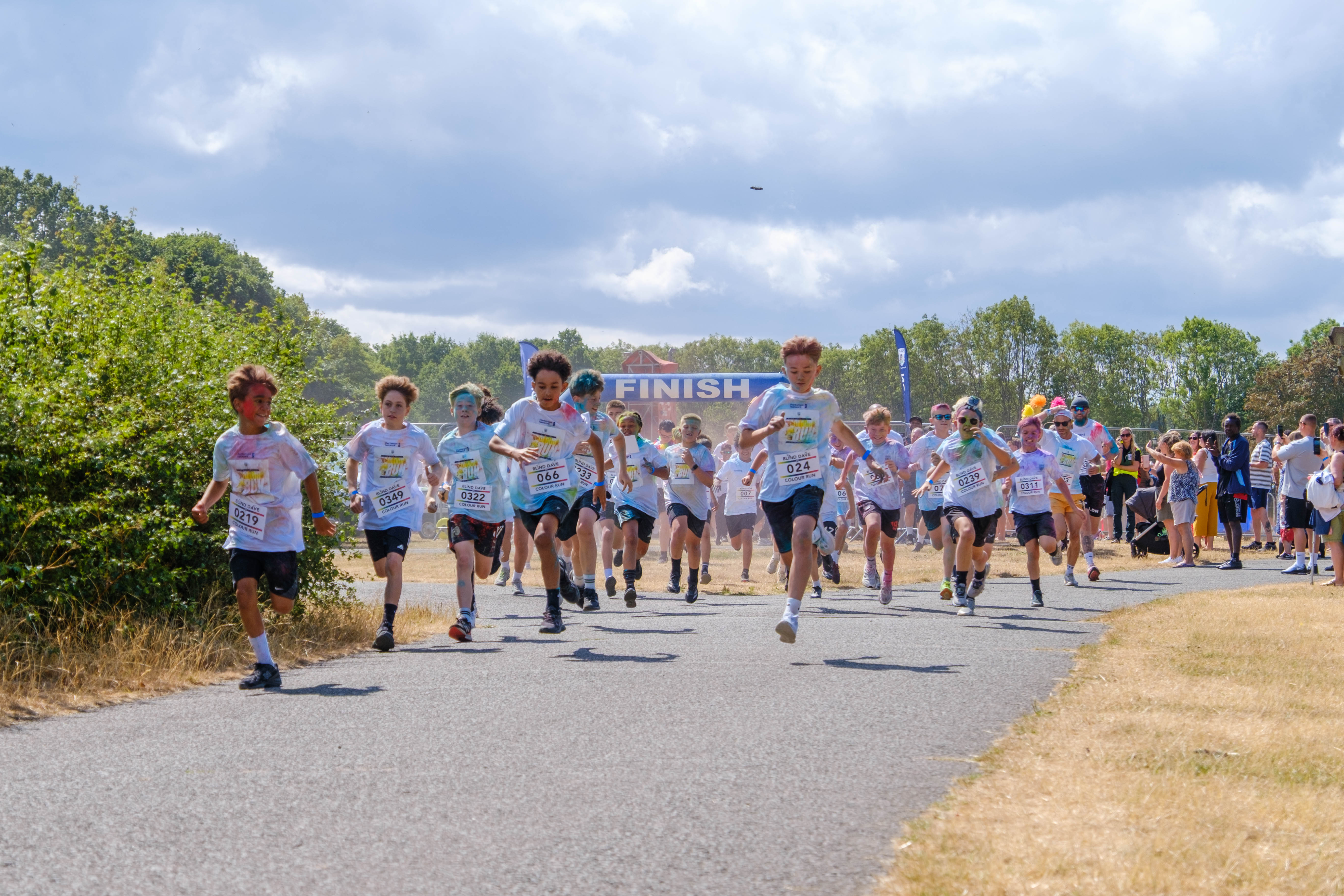 A large group of participants runs together along the event route.