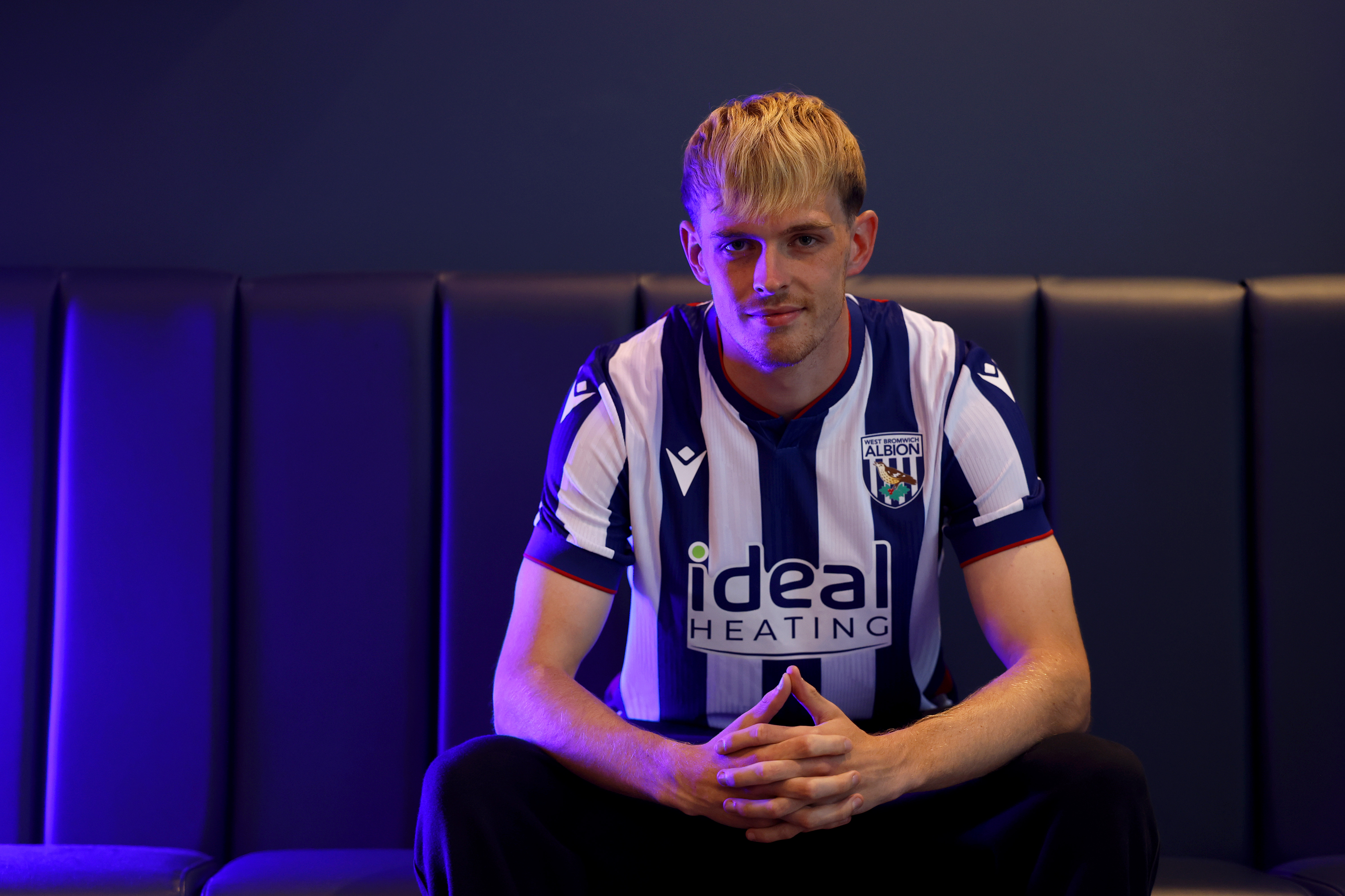 Toby Collyer poses in blue light