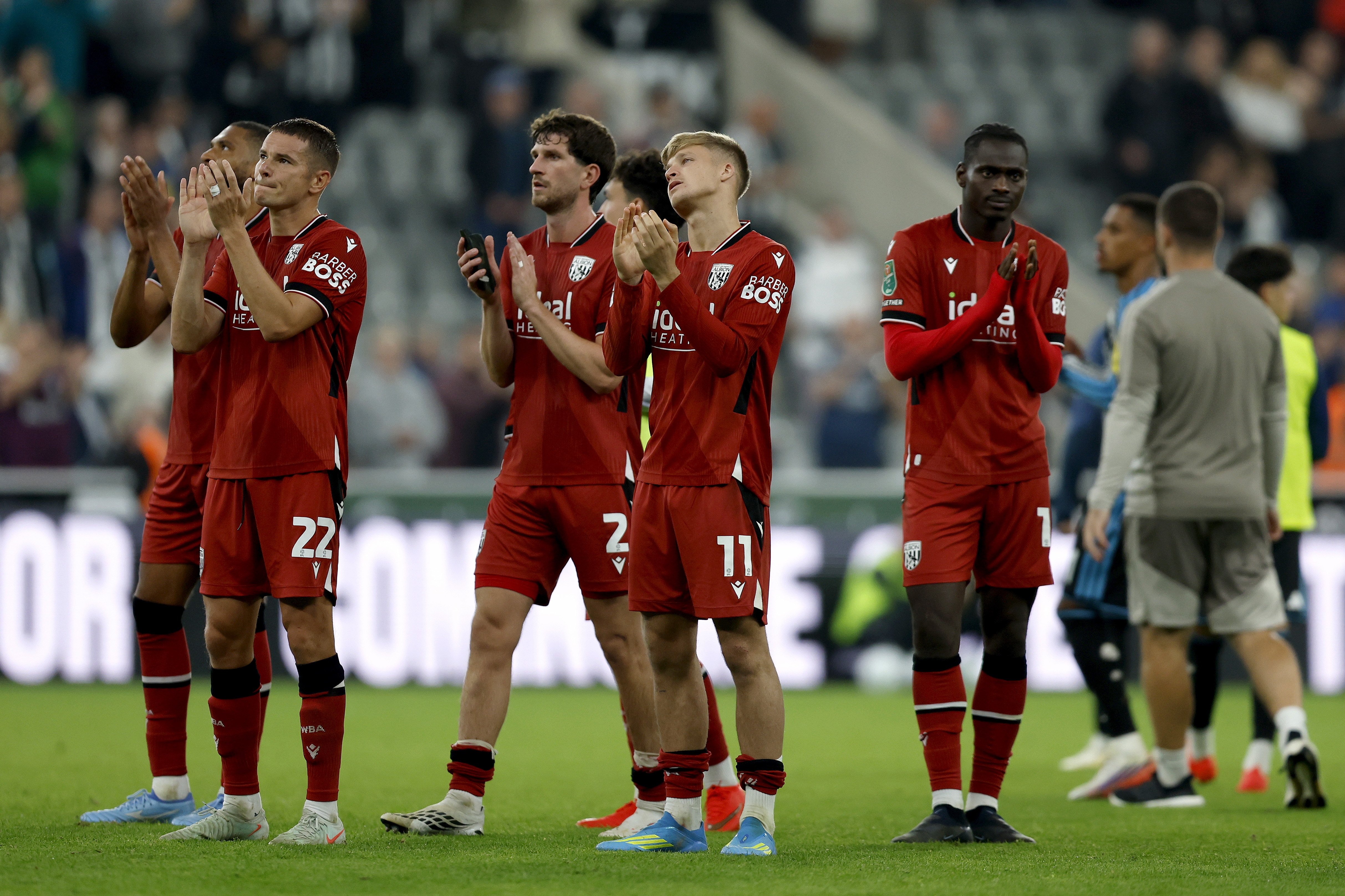 The players applaud the away fans at full-time
