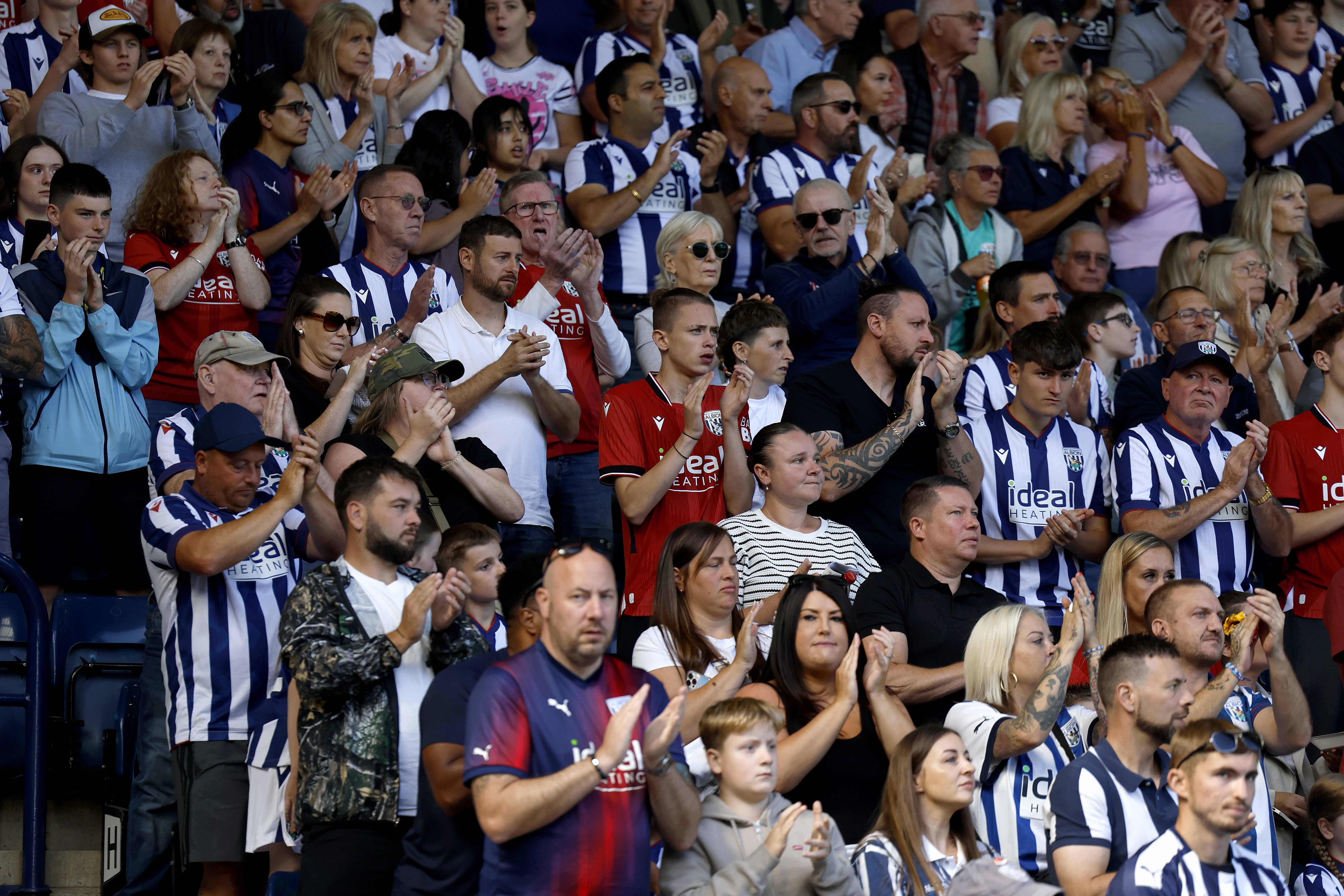 Albion fans applaud a goal at the Burnley game