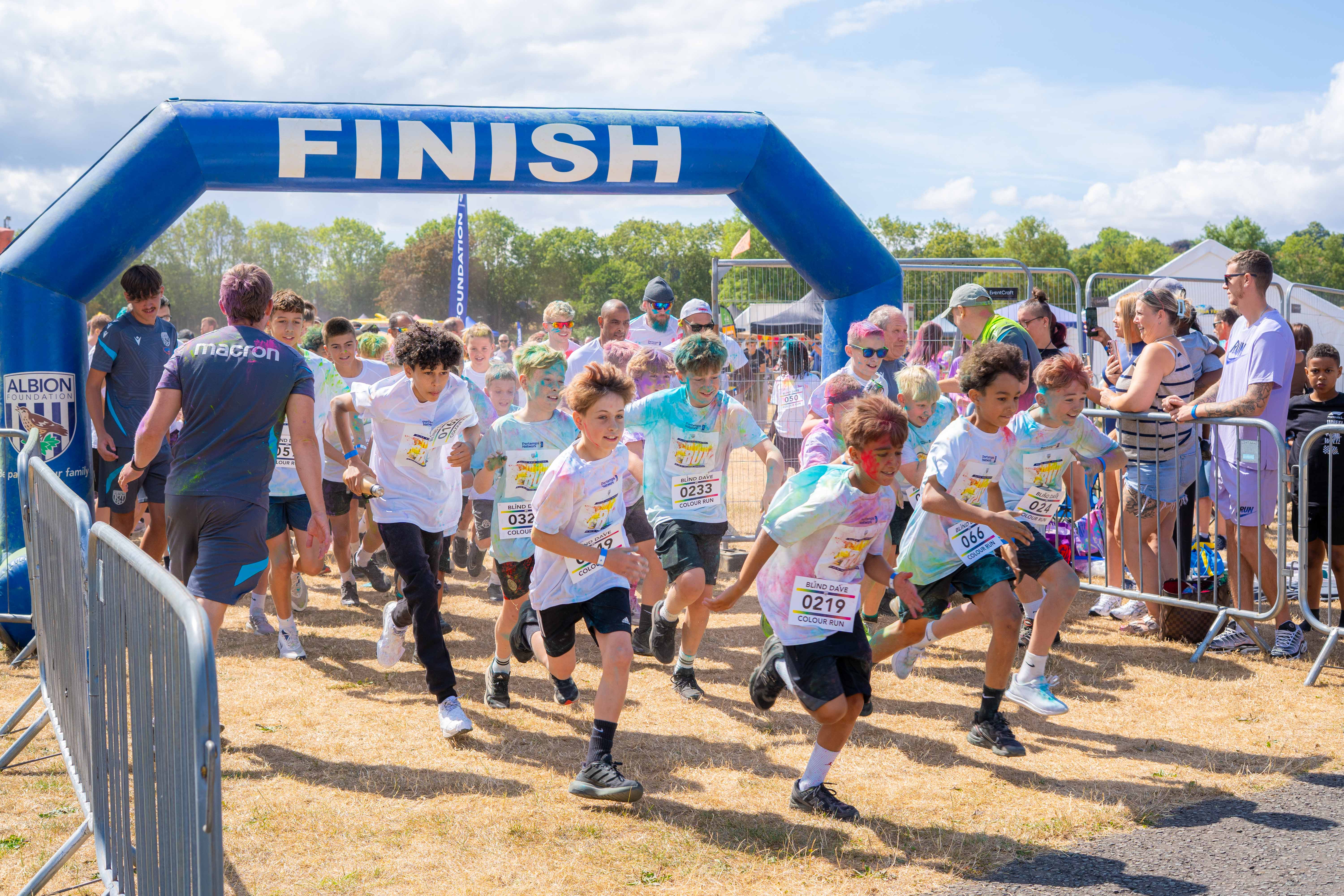 Participants running from the start line at the Colour Run