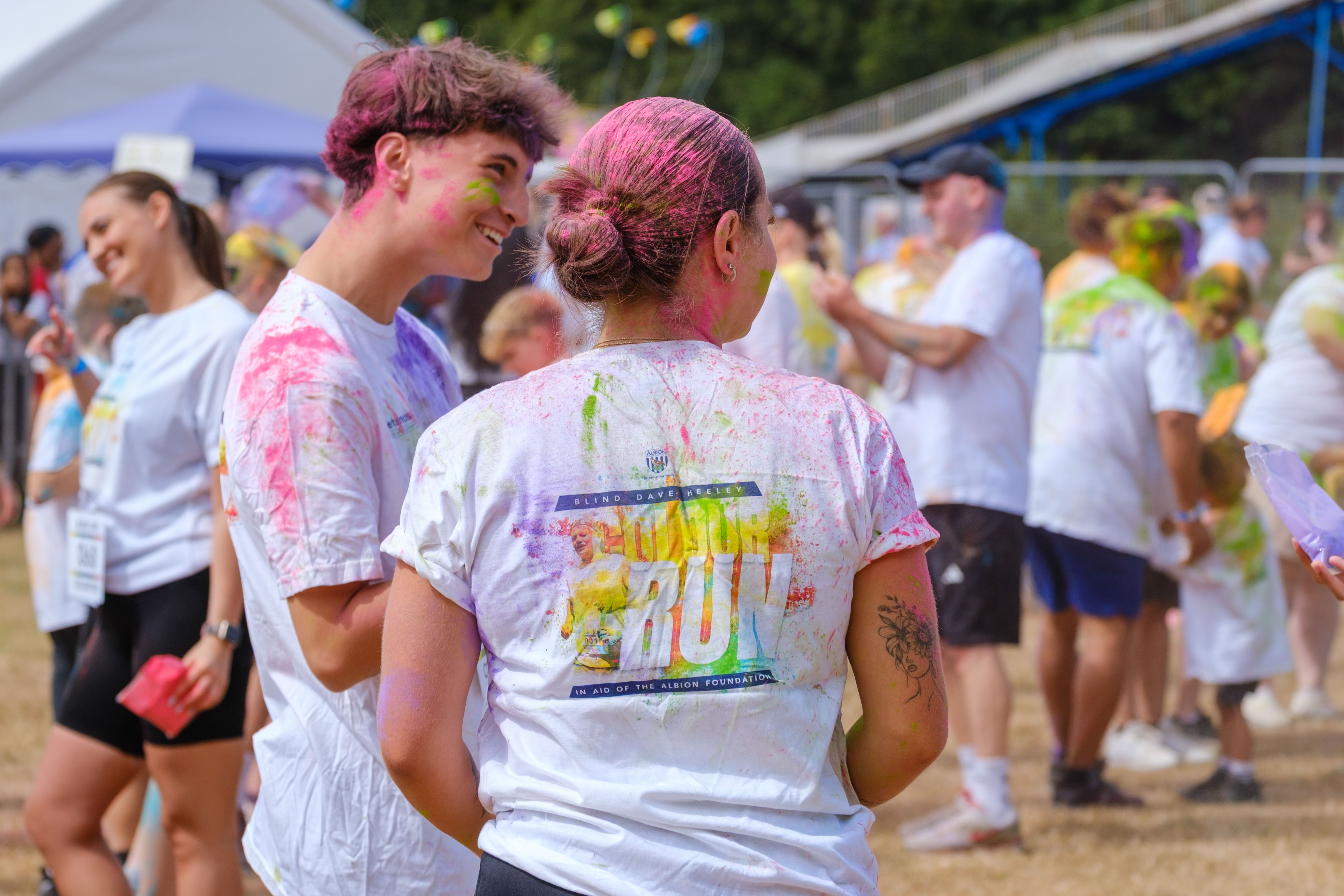Close up of the Blind Dave Colour run branding on the back of a participants shirt