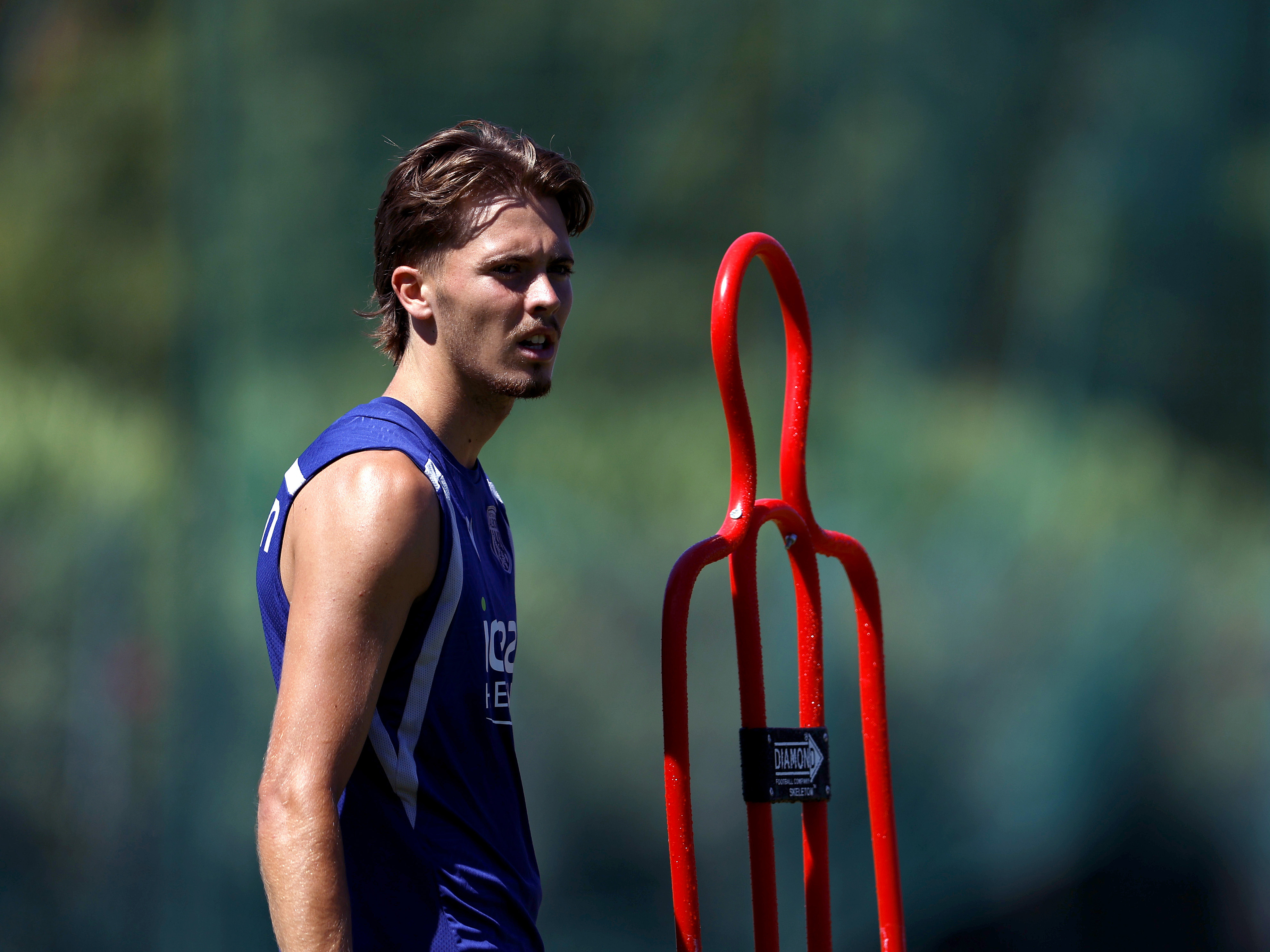 Isaac Price stood by a mannequin in training 