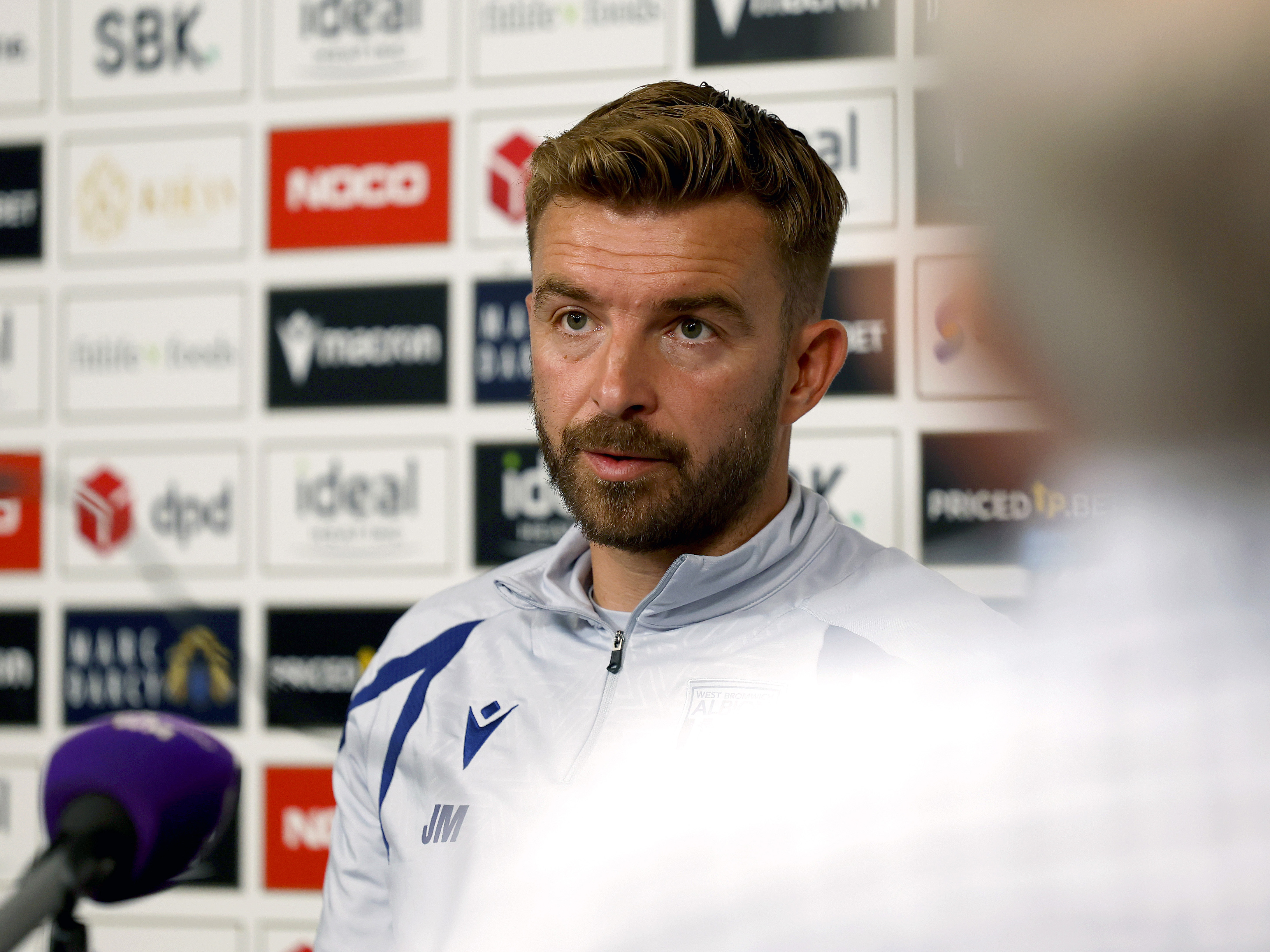 James Morrison speaking to the media in a press conference 