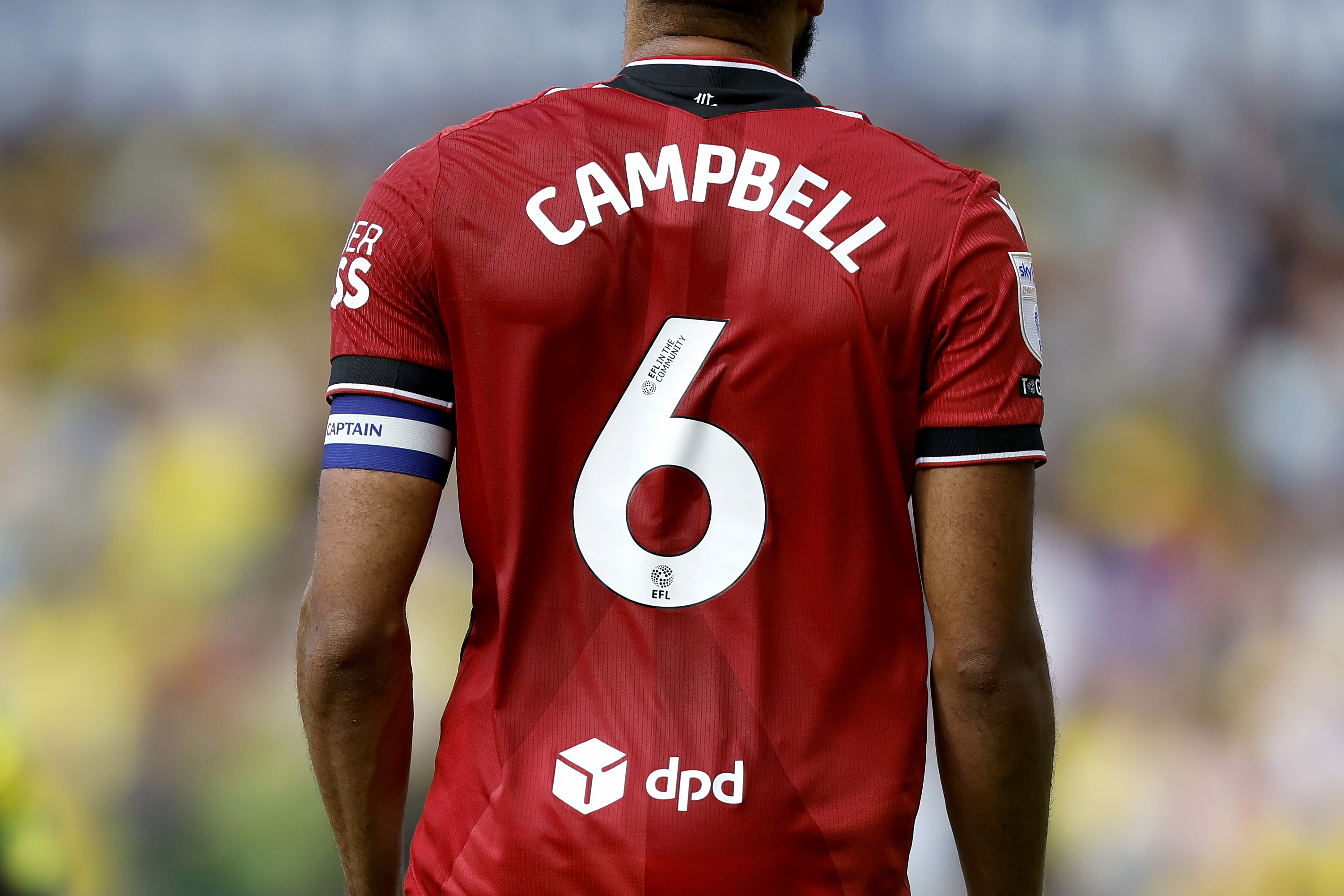 The back of George Campbell's red away shirt with his name and number 6 and captain's armband showing
