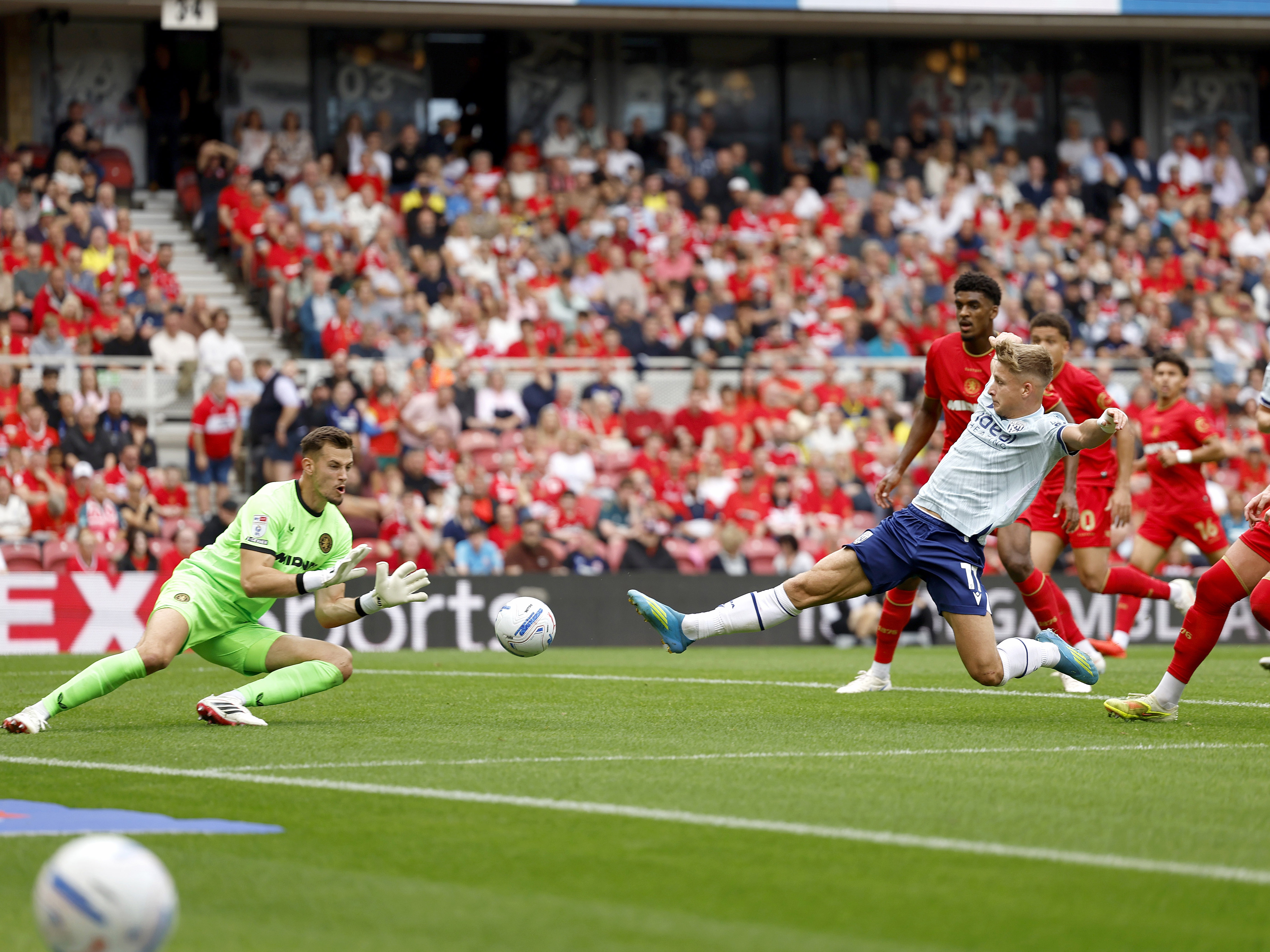 An image of JJ Morgan sliding towards a cross at Middlesbrough