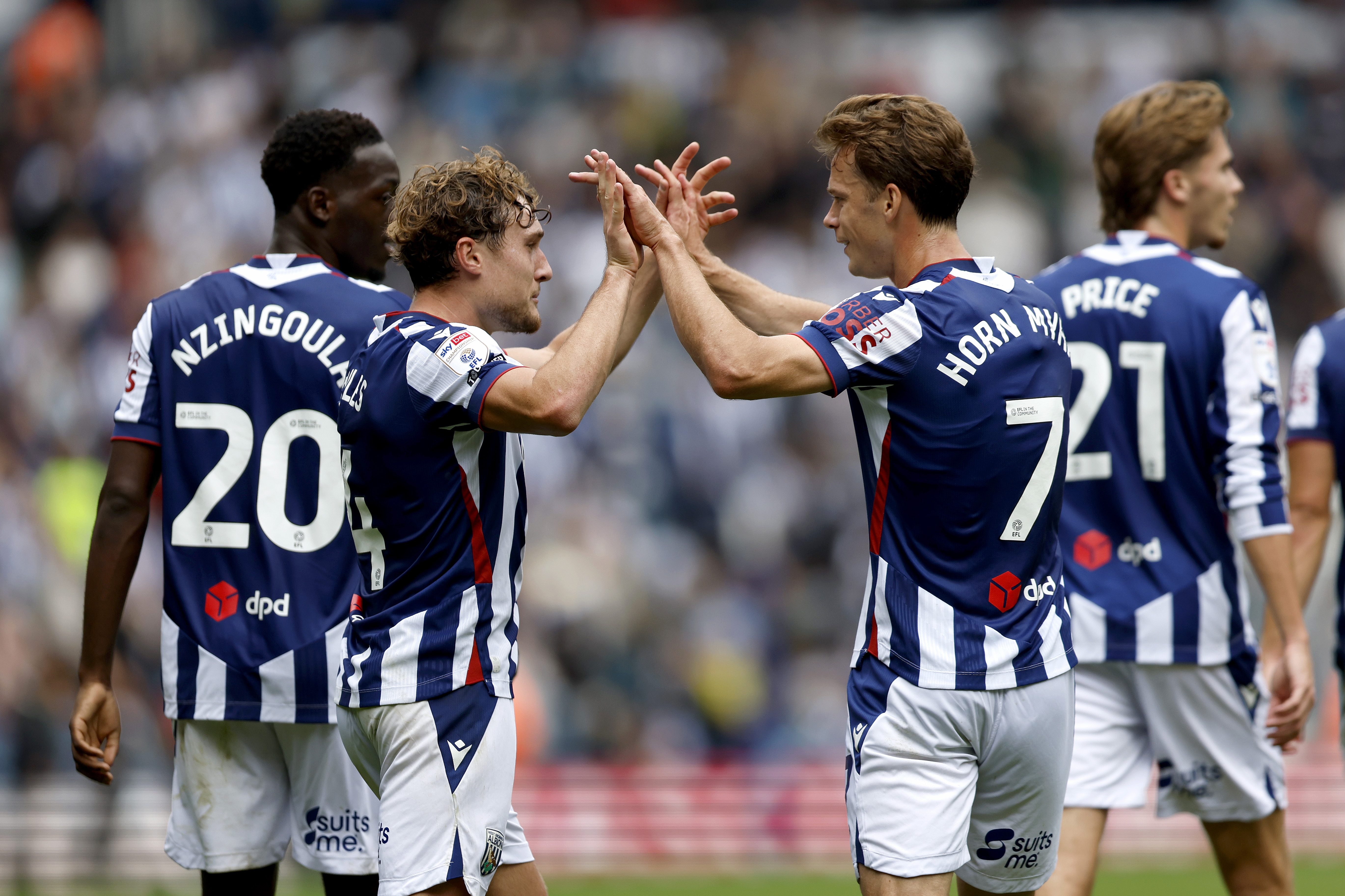 Callum Styles and Felix Horn Myhre celebrate after WBA's goal against QPR 