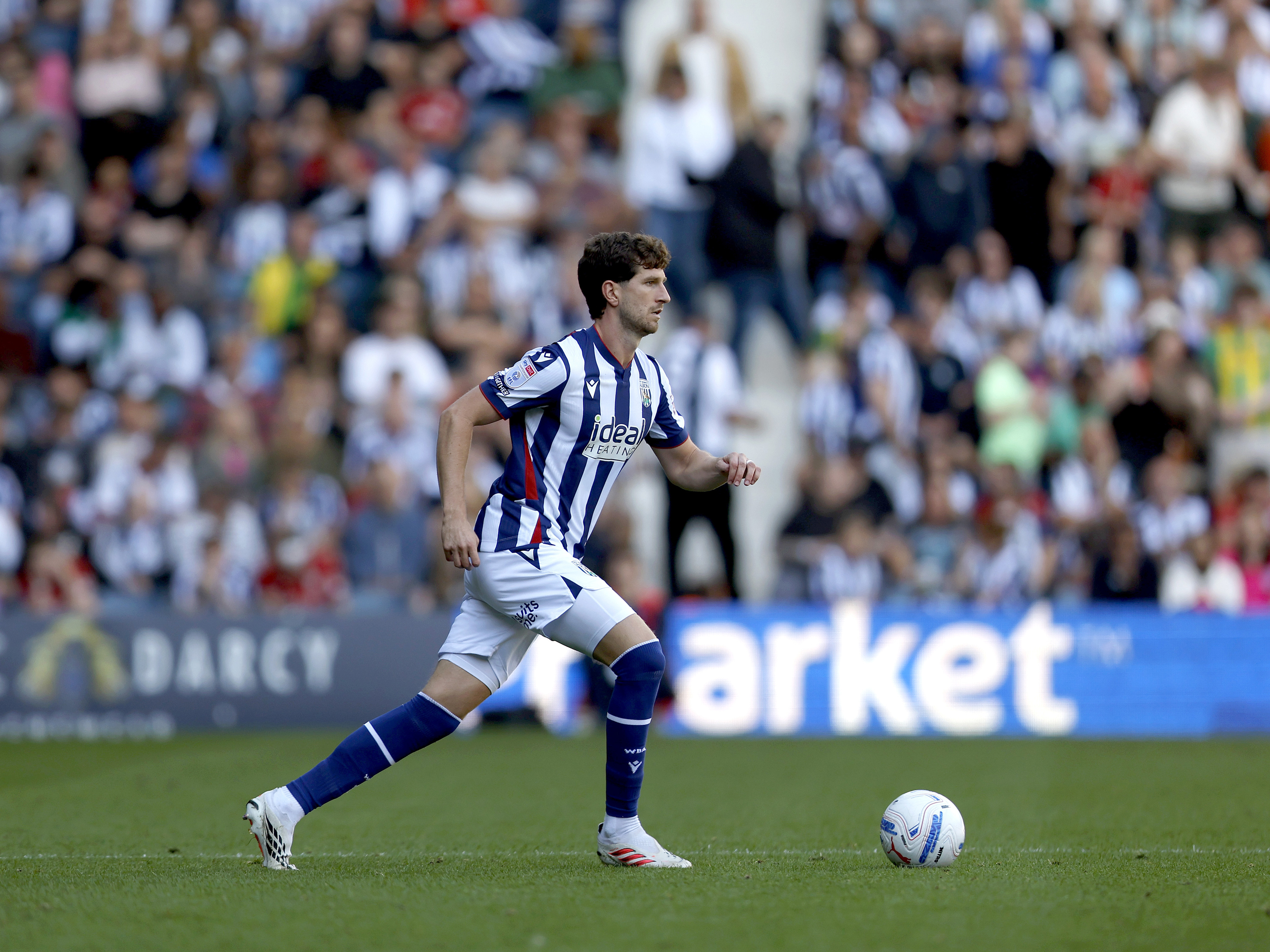 An image of Chris Mepham on the ball against Watford