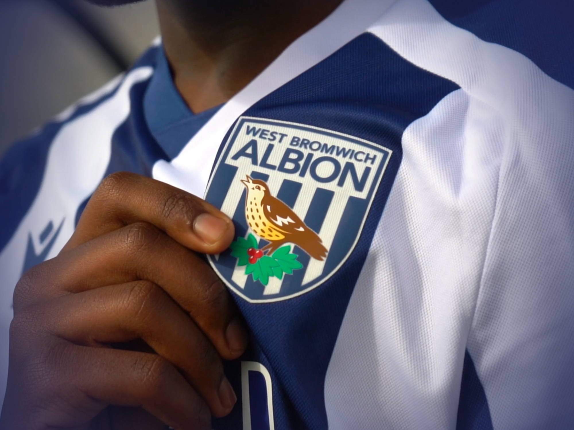 Participants hand holding the badge.
