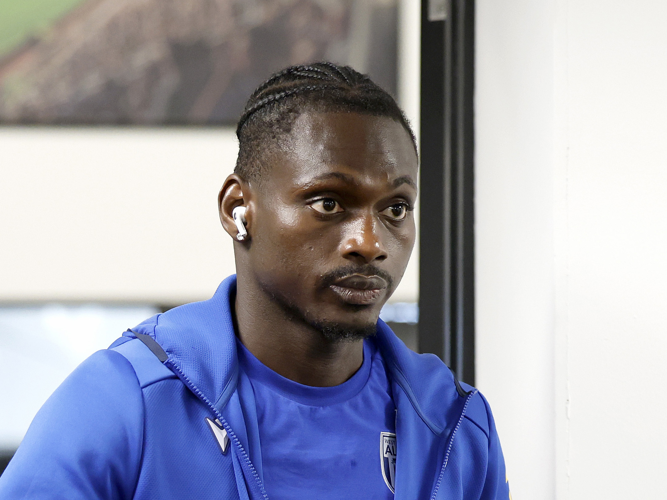 Ousmane Diakité arriving at a game in a blue WBA tracksuit 